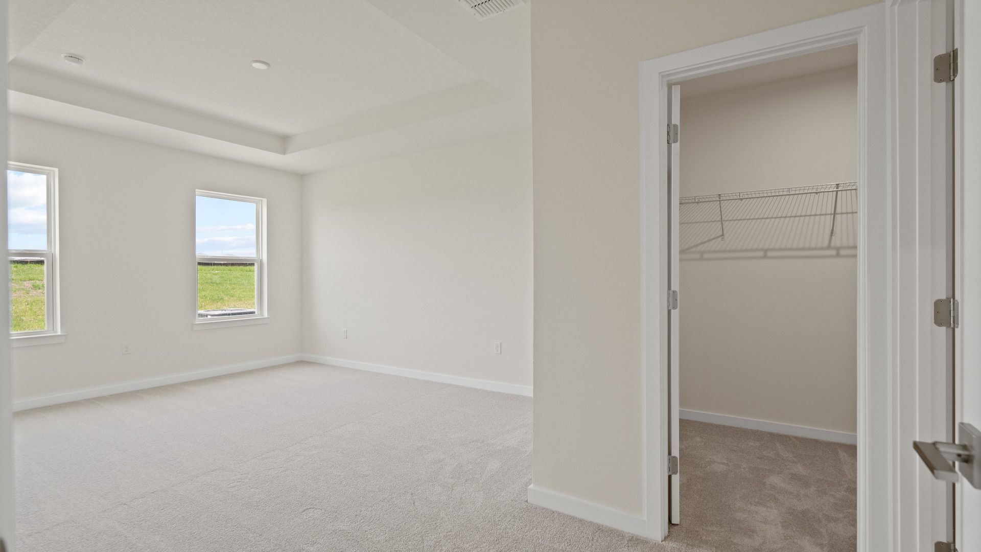 Atwood Primary Suite with Tray Ceiling and Walk-in Closet by DRB Homes in Liberty Trace New Homes in Haines City, FL