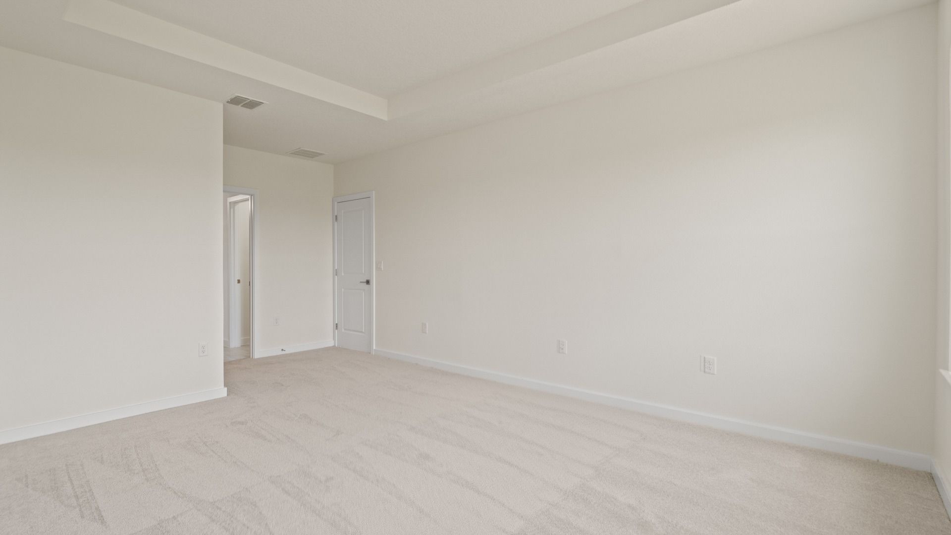 Atwood Primary Suite with Tray Ceiling and Walk-in Closet by DRB Homes in Liberty Trace New Homes in Haines City, FL