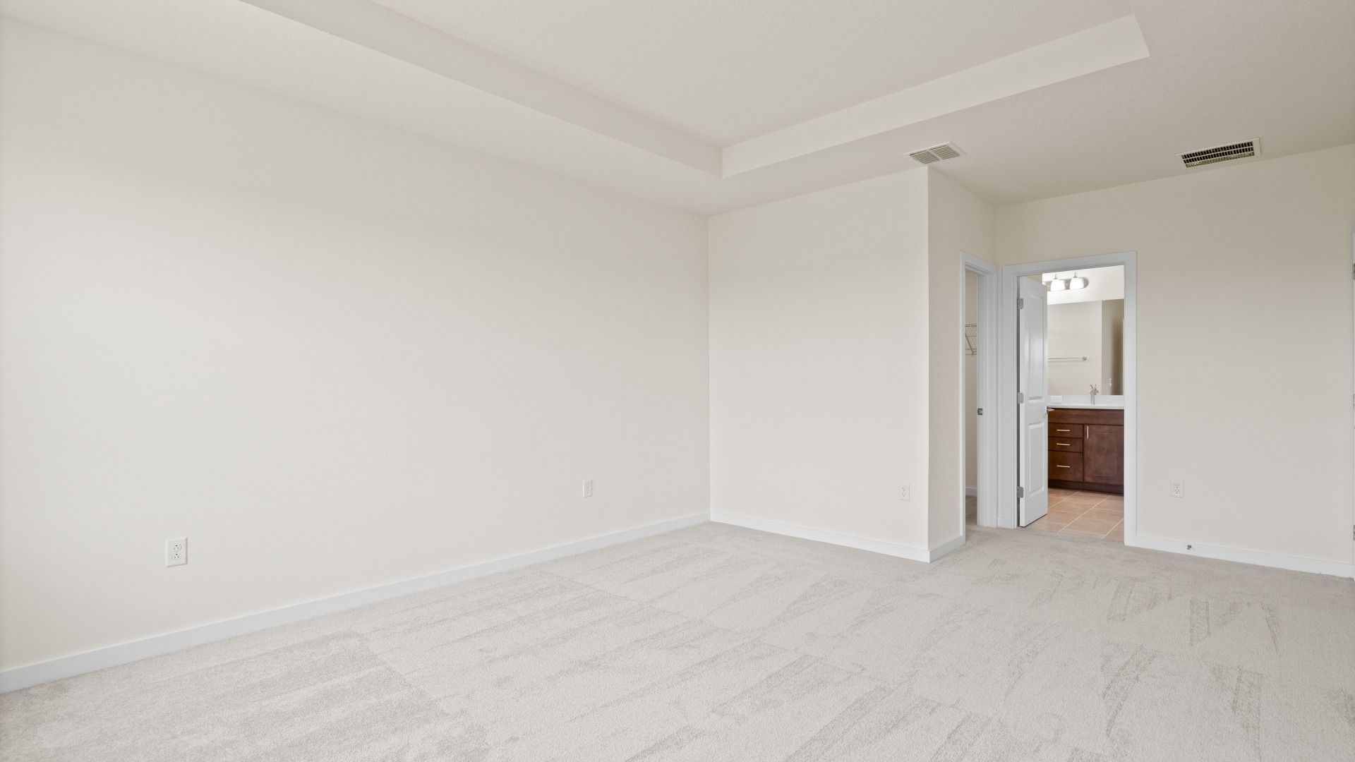 Atwood Primary Suite with Tray Ceiling and Walk-in Closet by DRB Homes in Liberty Trace New Homes in Haines City, FL