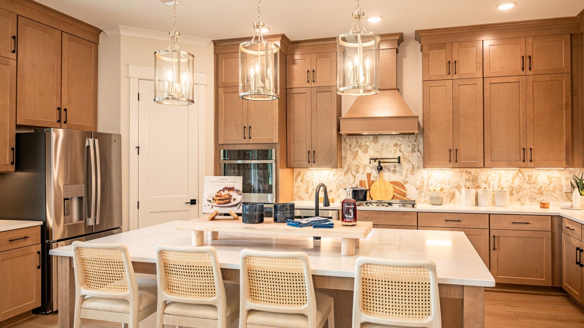 Kitchen with quartz countertops, pendant lighting, and tile backsplash
