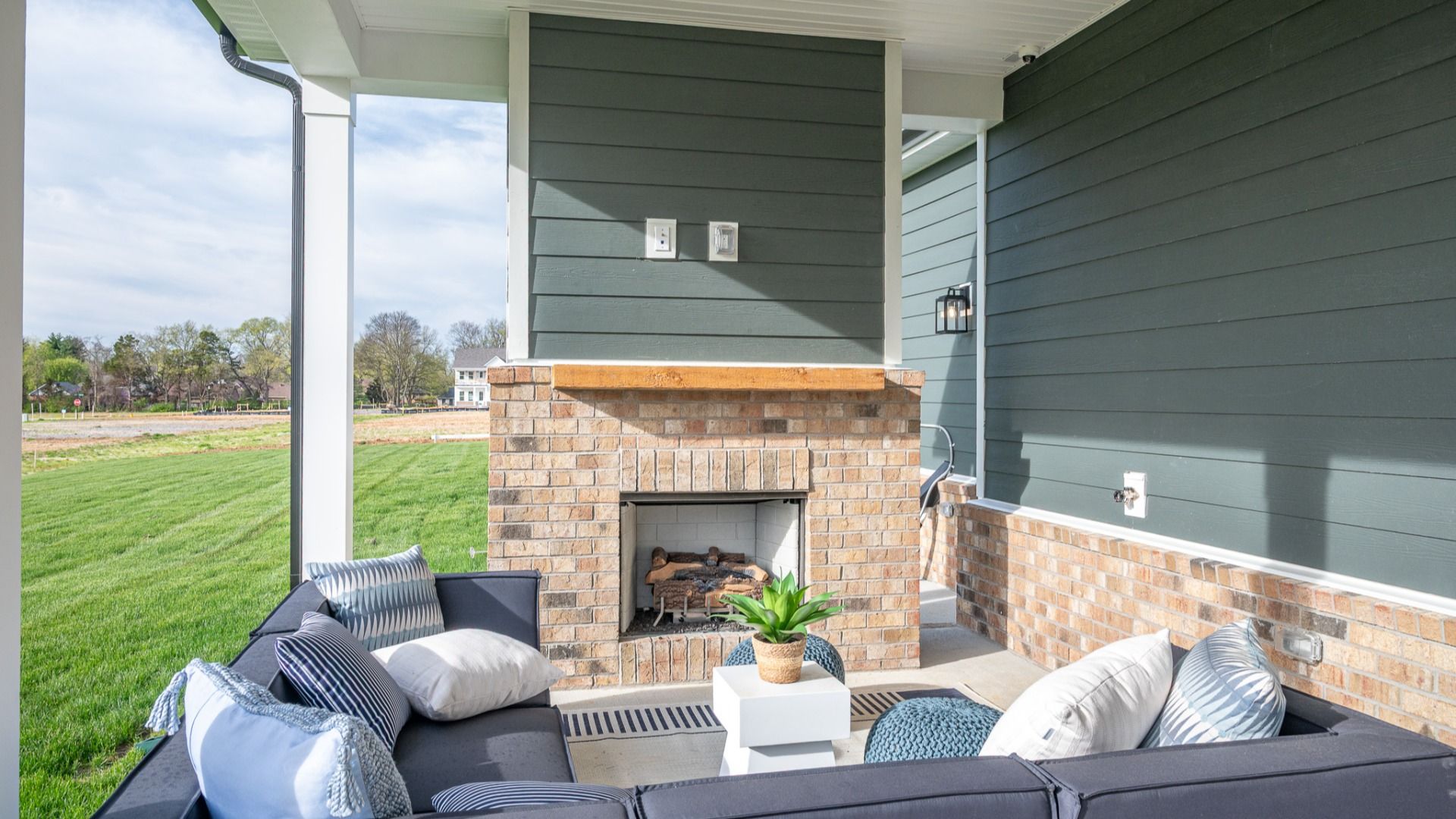 Covered rear patio with centered fireplace