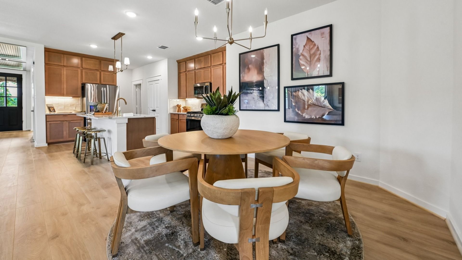 Luxurious wood accents and chic pendant lighting define this elegant dining space in Cielo community.