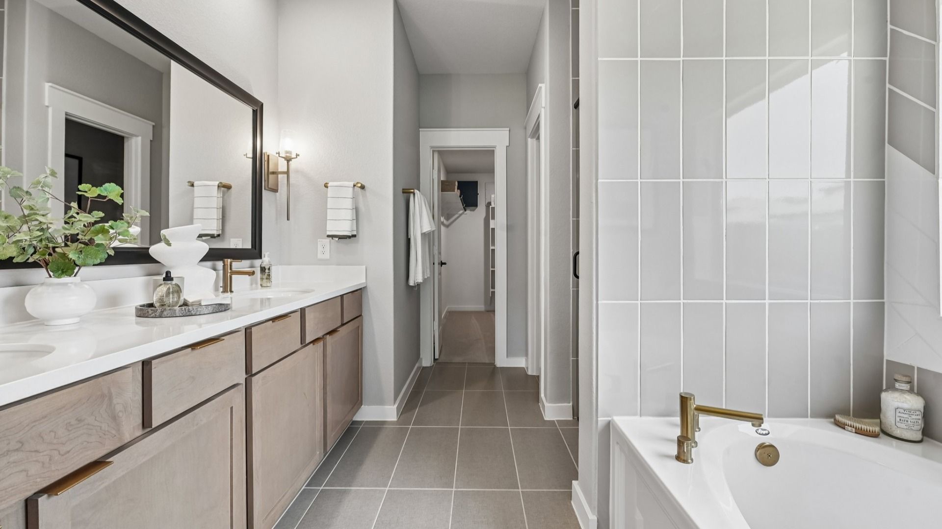 Elegant bathroom in Cielo featuring marble counters, dual sinks, and luxe gold fixtures. Exquisite design.