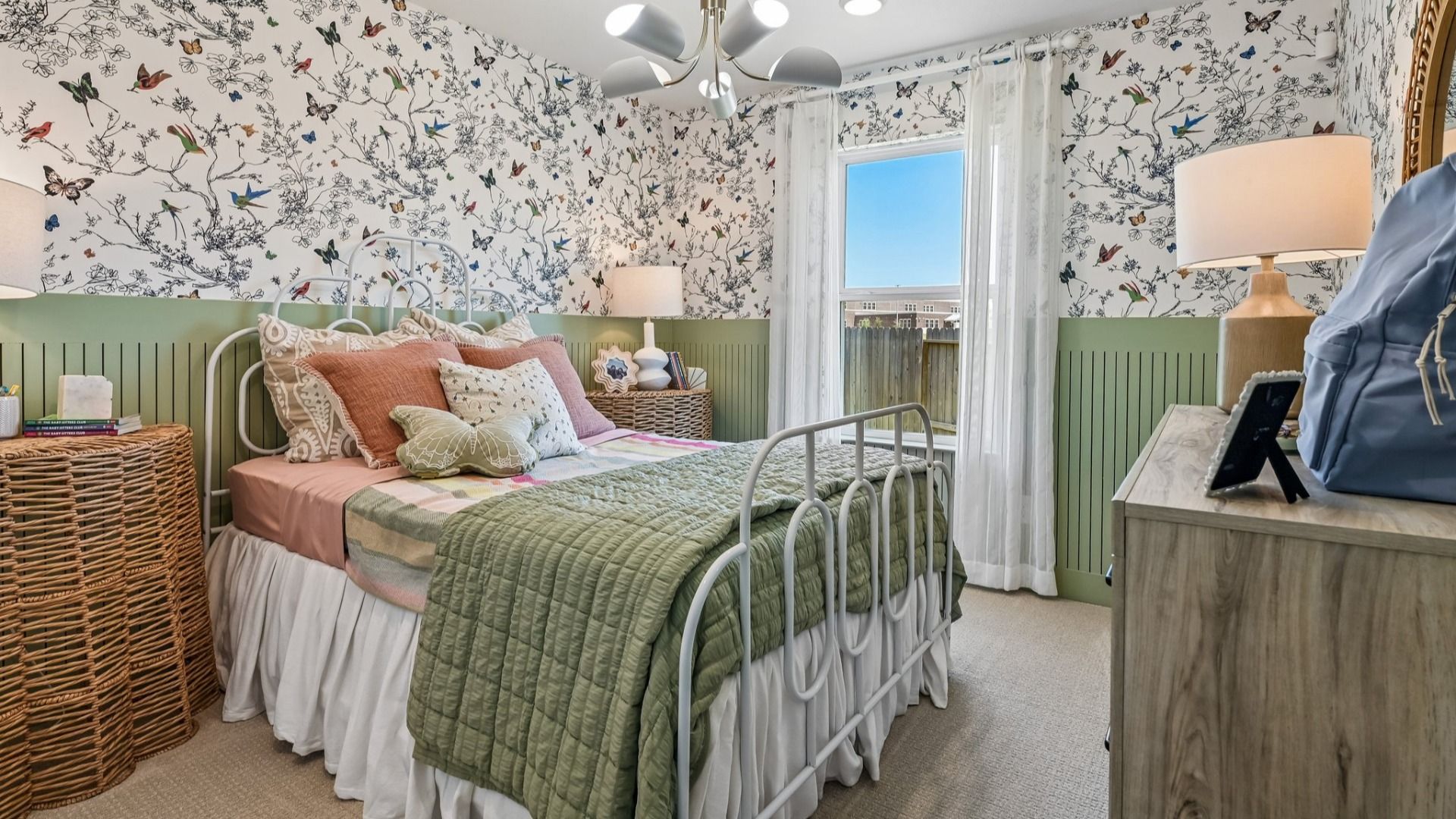 Exquisite floral wallpaper complemented by wicker accents exemplifies luxury in Cielo's bedroom design.