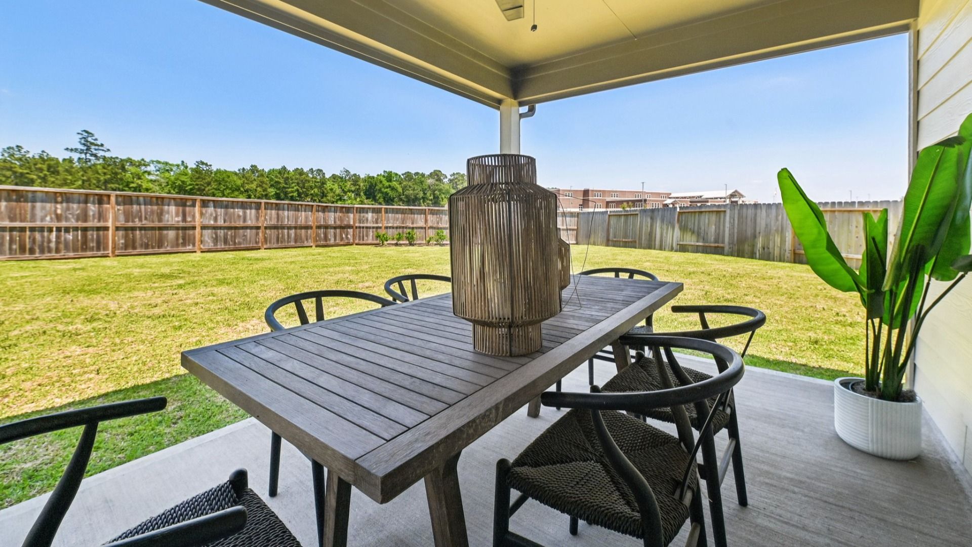 Enjoy a serene outdoor retreat with a covered patio and expansive lawn in beautiful Cielo.