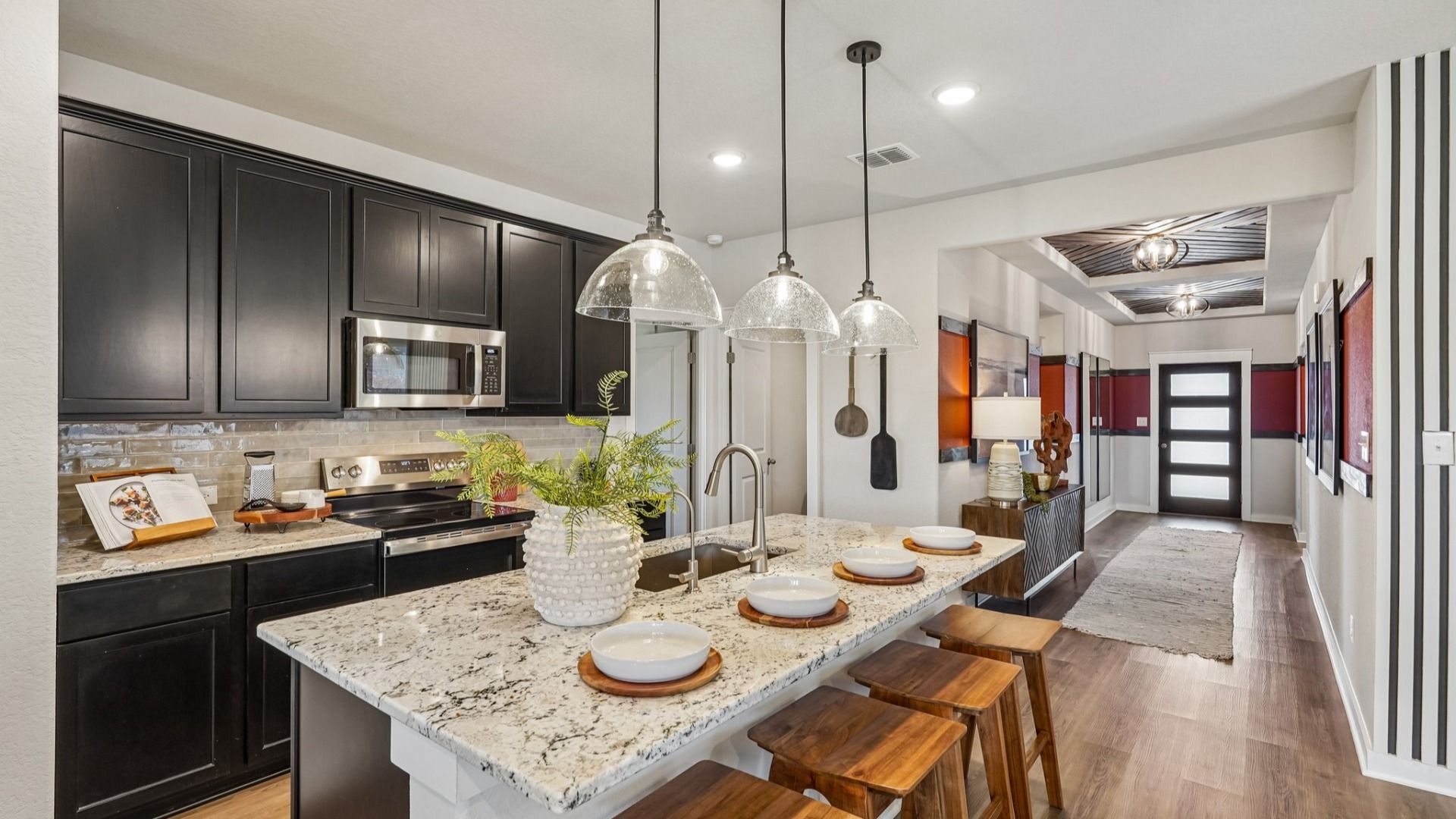 Kitchen features beautiful glass pendant lighting, a center island, and is located near the Flex Room & Laundry