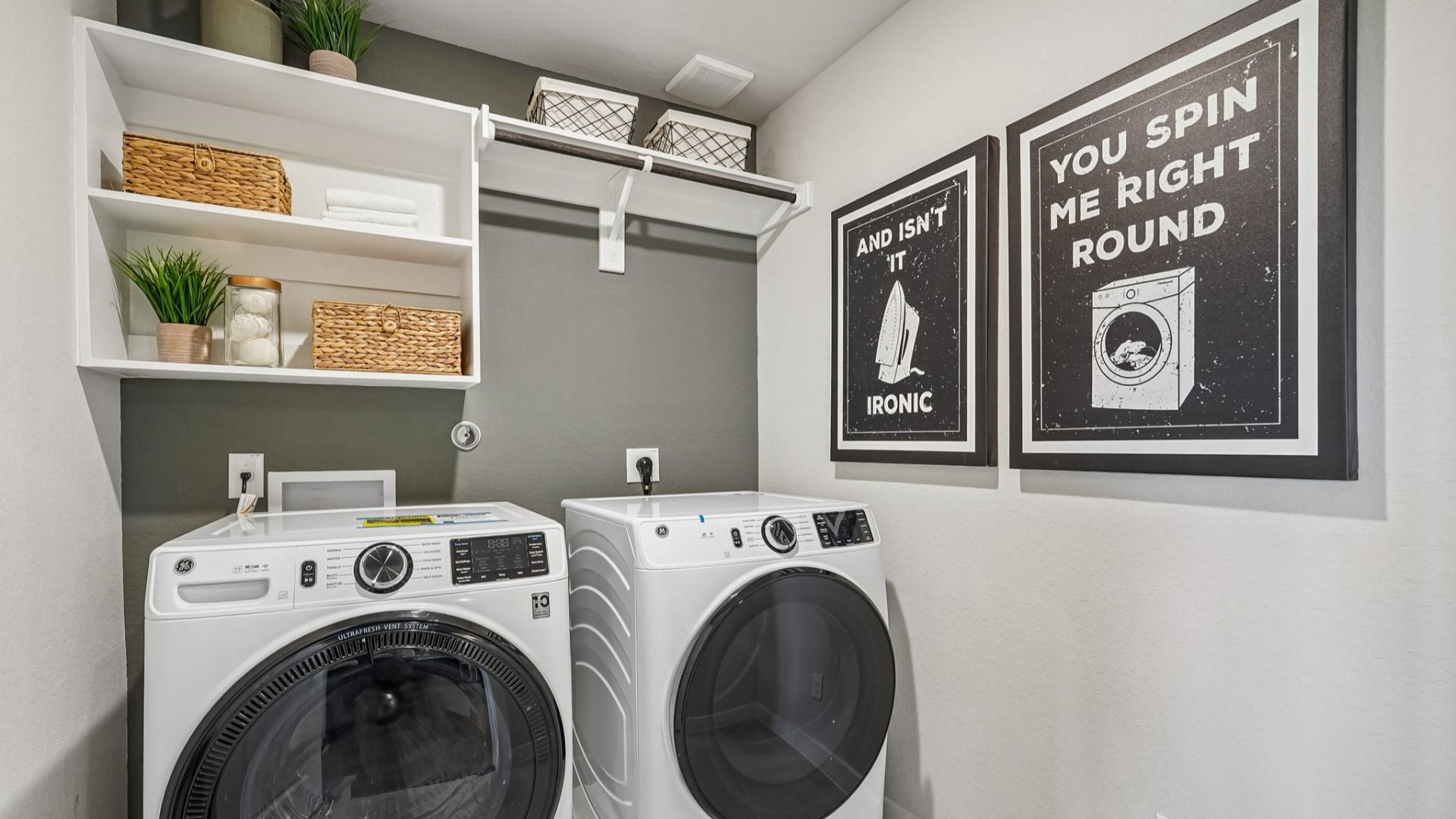 Laundry complete with shelving and hanging rod, creating a functional space.