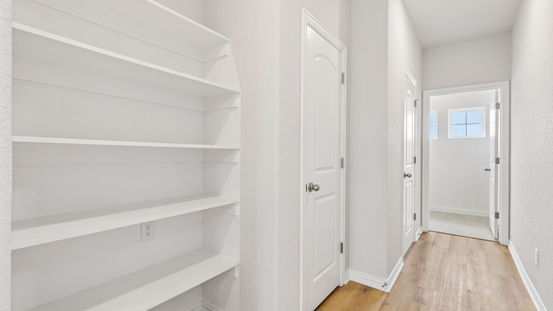 Plenty of built-in shelving conveniently located near the laundry room