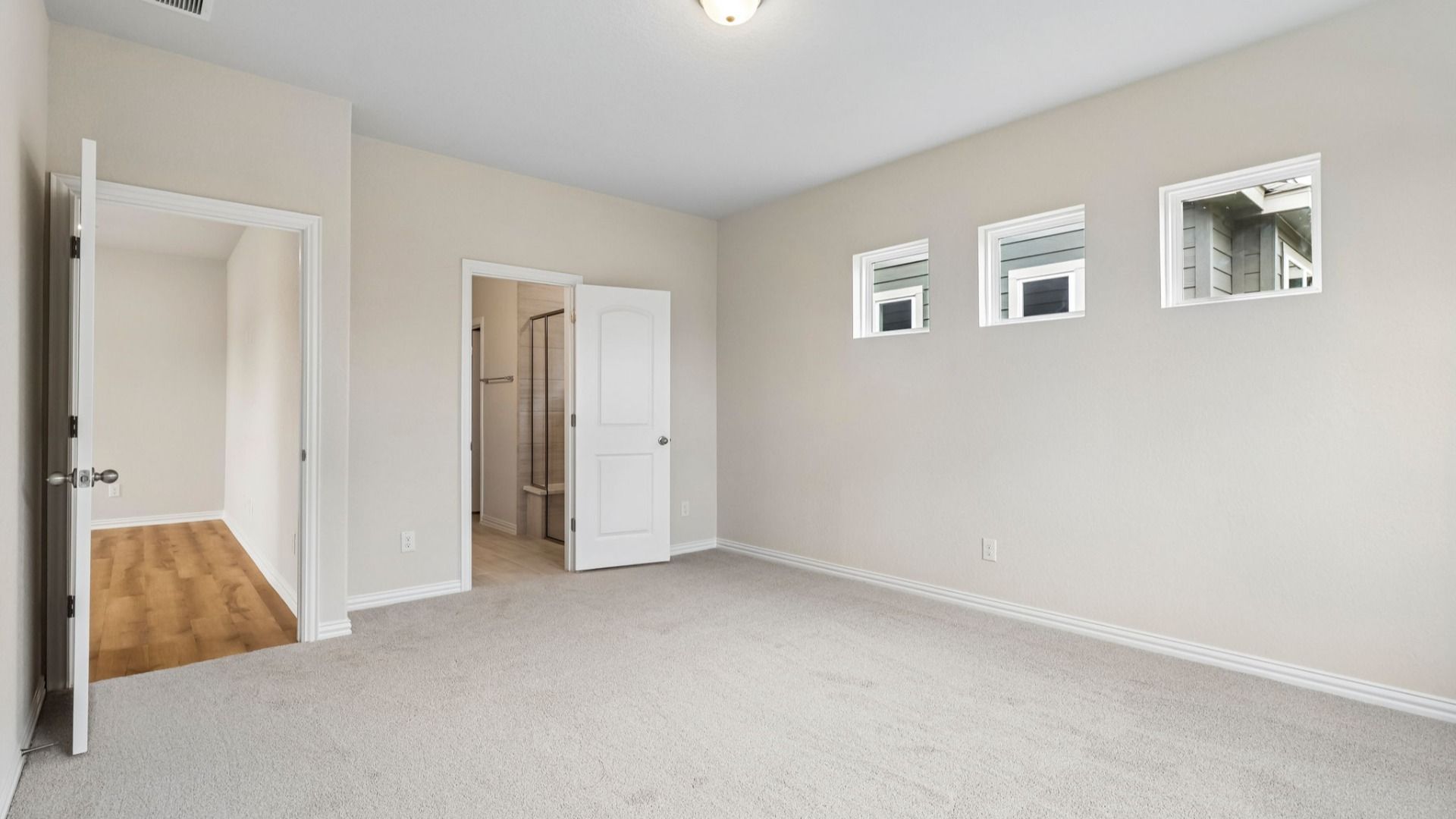 Owner's Suite has three additional windows for natural light and is located on the main level of the home