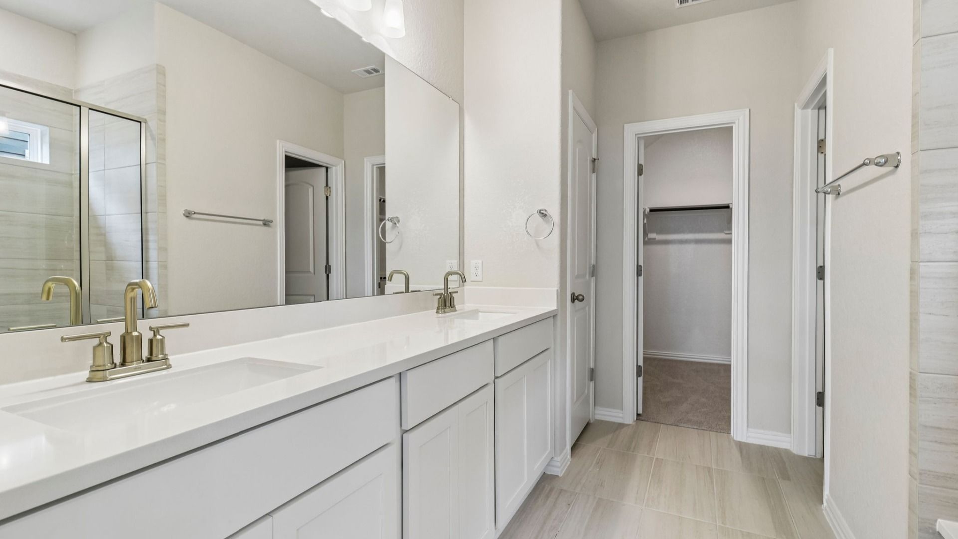 Owner's Bath has bright cabinets, dual vanity and a large shower with a window for natural light