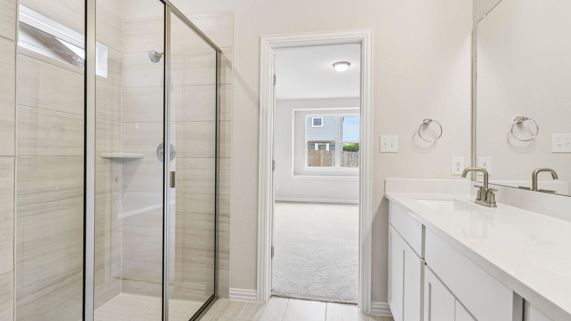 Owner's Bath has bright cabinets, dual vanity and a large shower with a window for natural light