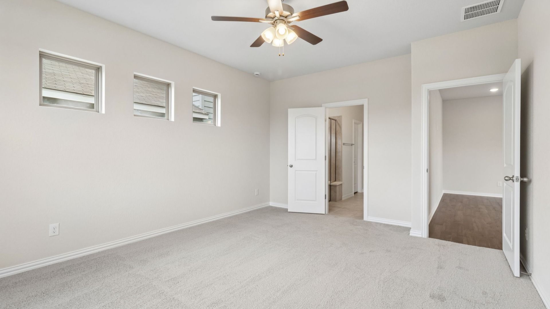 Owner's Suite has three additional windows for natural light and is located on the main level of the home