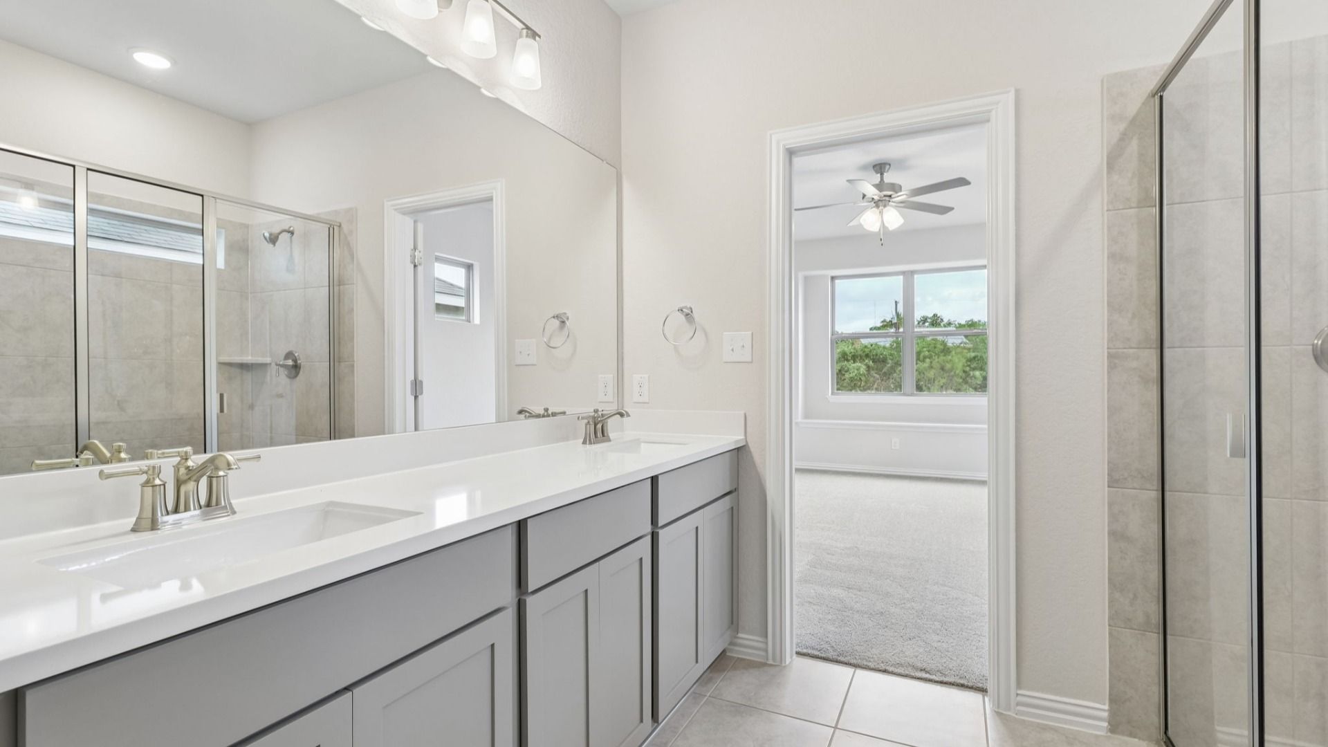 Owner's Bath has bright cabinets, dual vanity and a large shower with a window for natural light
