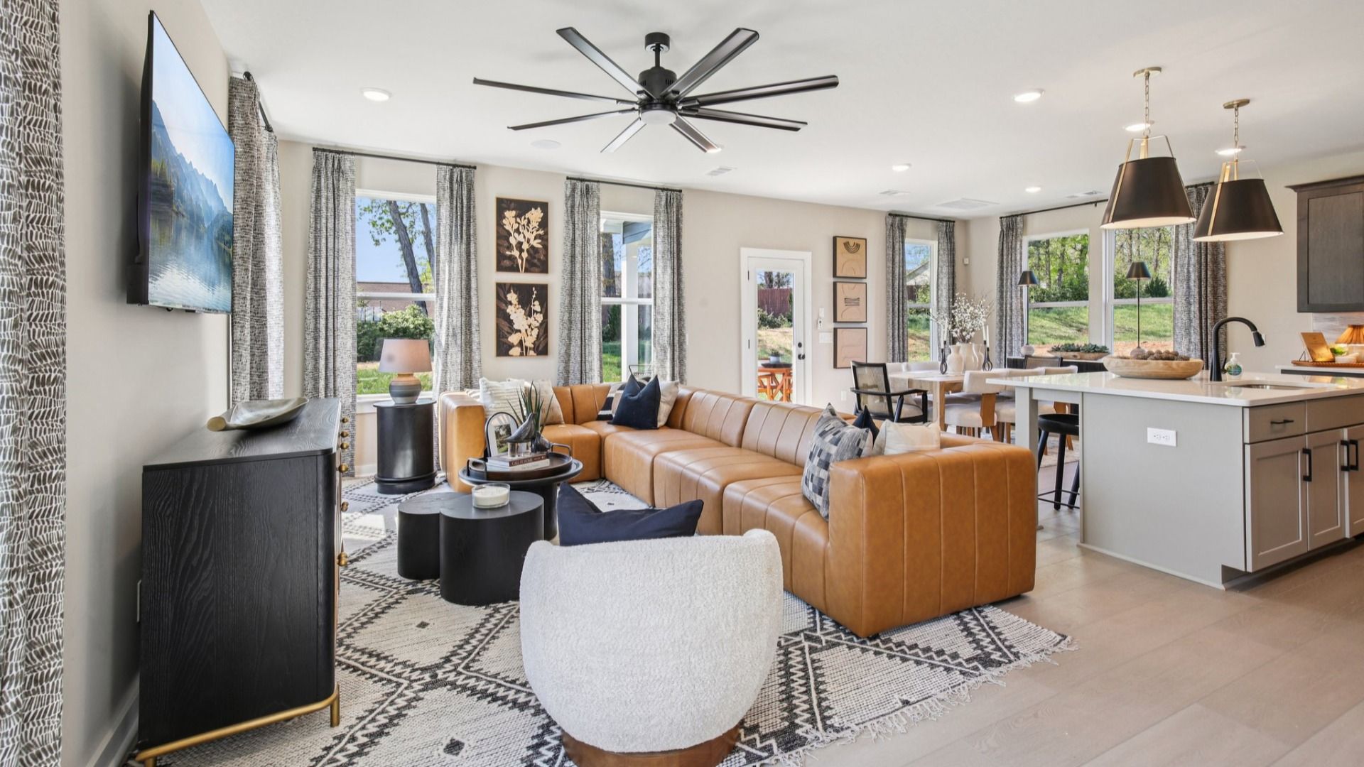 Open concept first floor living room, kitchen, and dining area