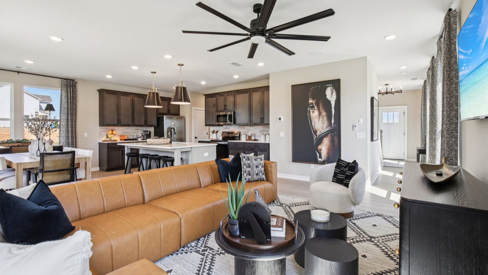 Open concept first floor living room, kitchen, and dining area