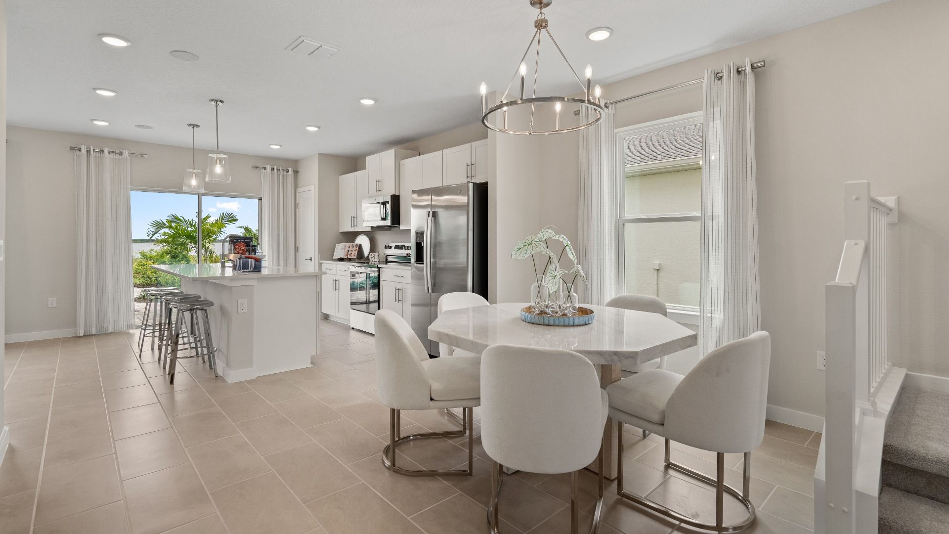 Open Concept Dining and Kitchen Area in Ponte Vedra New Home Plan in Hamilton Bluff in Haines City, FL by DRB Homes