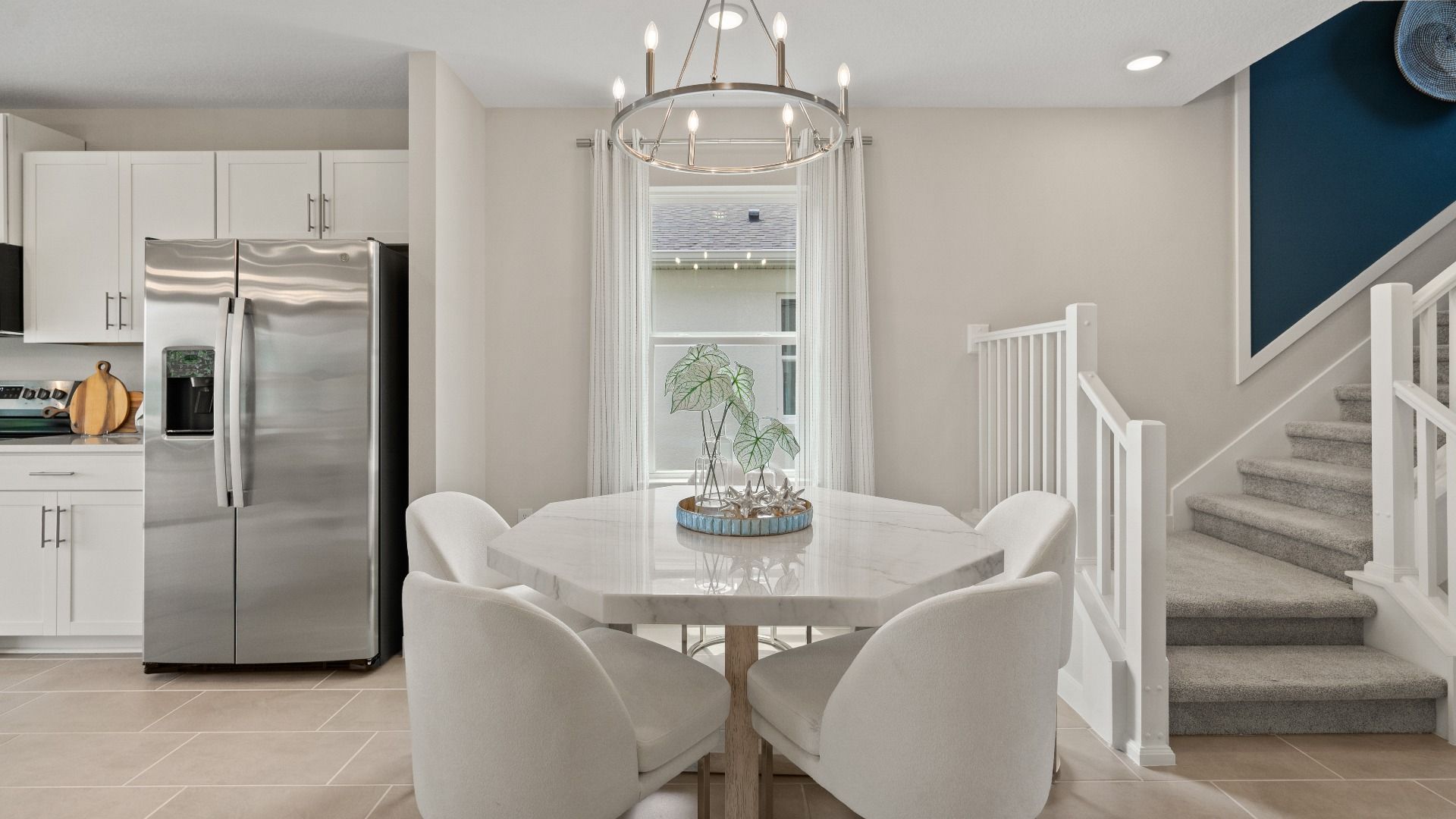 Open Concept Dining and Kitchen Area in Ponte Vedra New Home Plan in Hamilton Bluff in Haines City, FL by DRB Homes