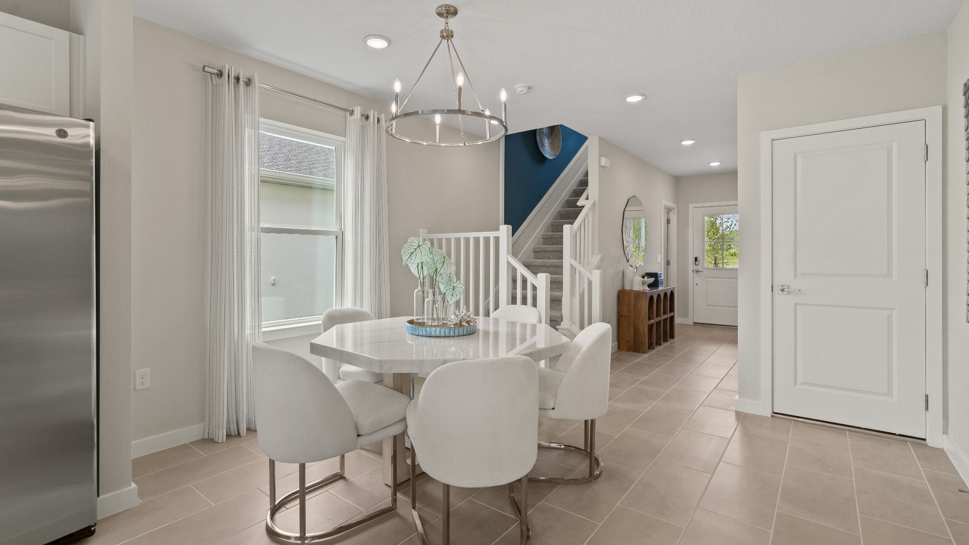 Open Concept Dining and Kitchen Area in Ponte Vedra New Home Plan in Hamilton Bluff in Haines City, FL by DRB Homes