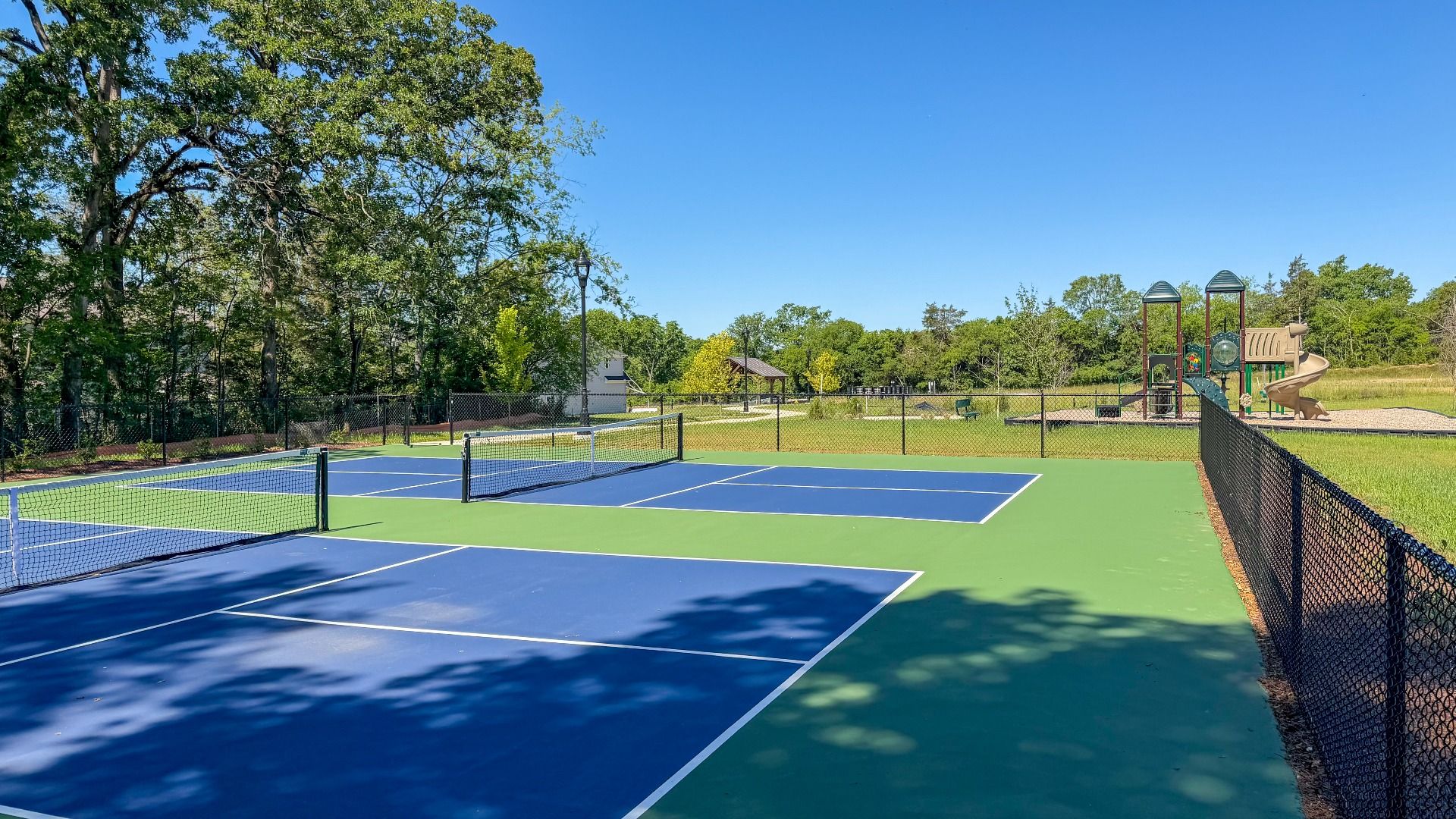 Pickleball Court with Playground in Background