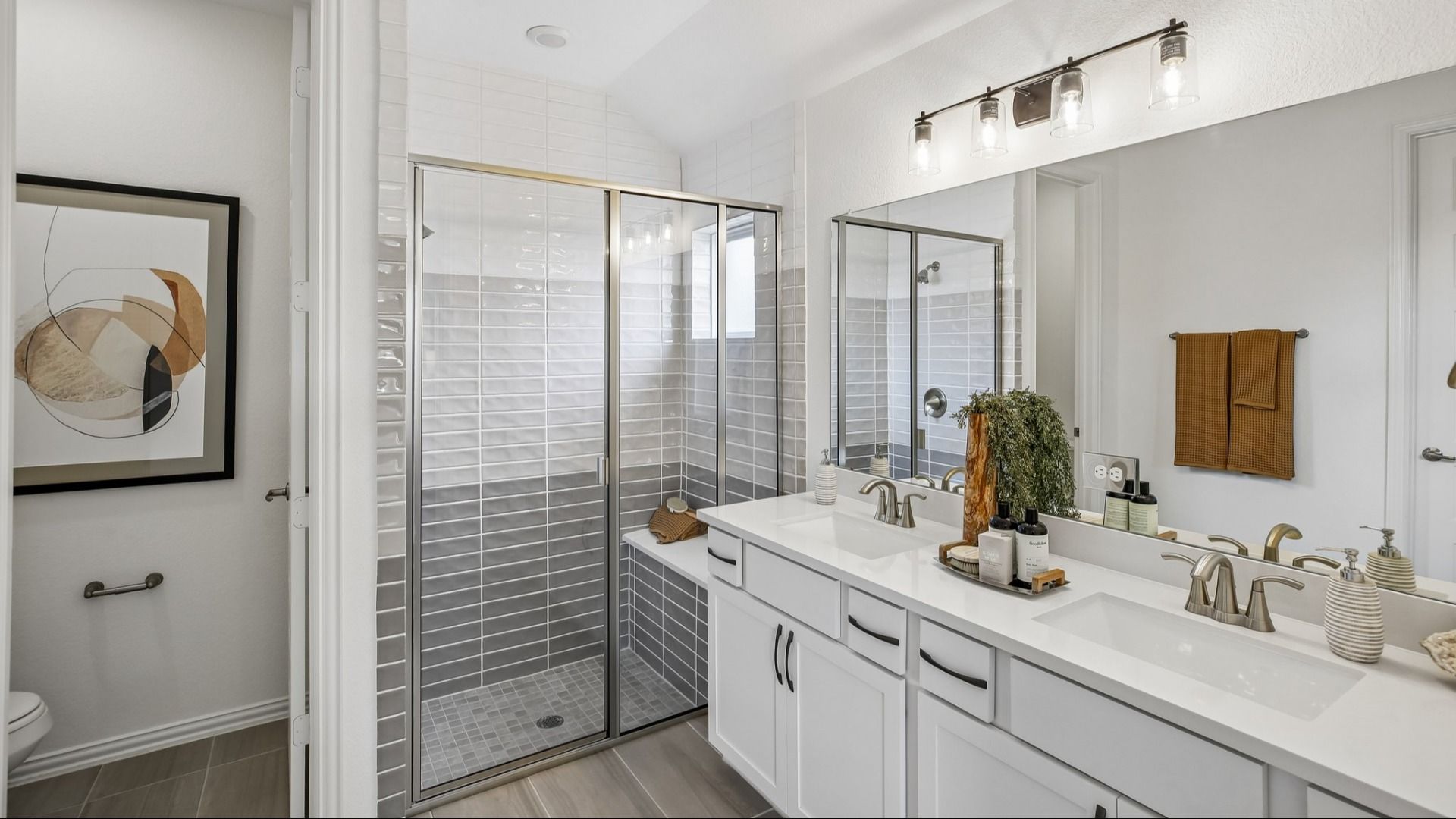 Luxurious bathroom in Cypress Green features sleek dual sinks and elegant glass shower enclosure.