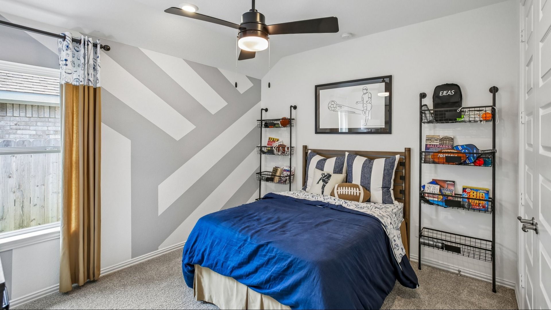 Discover refined comfort in this Cypress Green bedroom with a chic geometric wall and upscale sports accents.