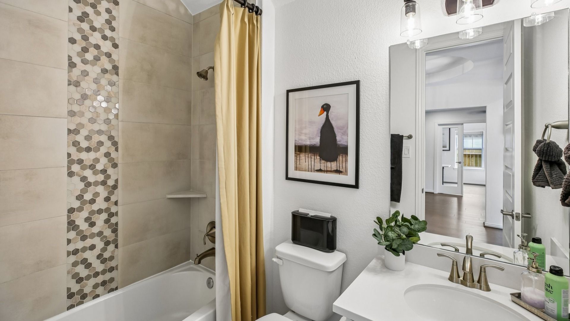Luxurious bathroom features chic hexagonal tiles and premium fixtures in the Cypress Green community.