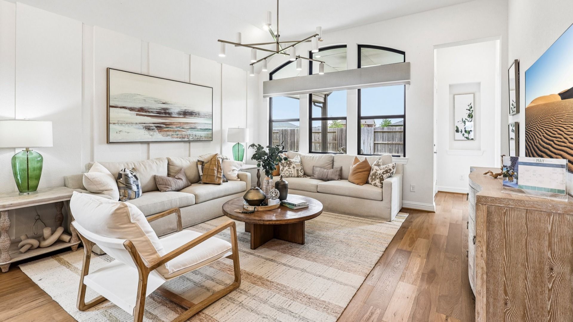 Elegant chandeliers and large windows define this refined Sunterra masterpiece.
