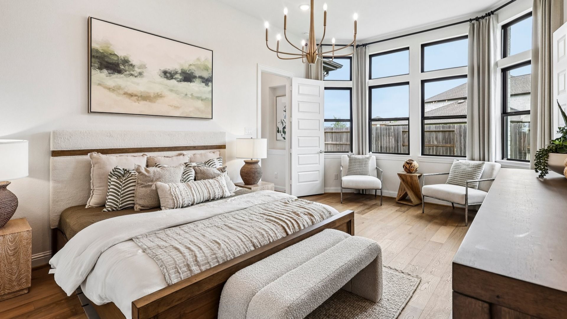 Experience sophistication with high ceilings and abundant natural light in Sunterra community's exquisite bedroom.