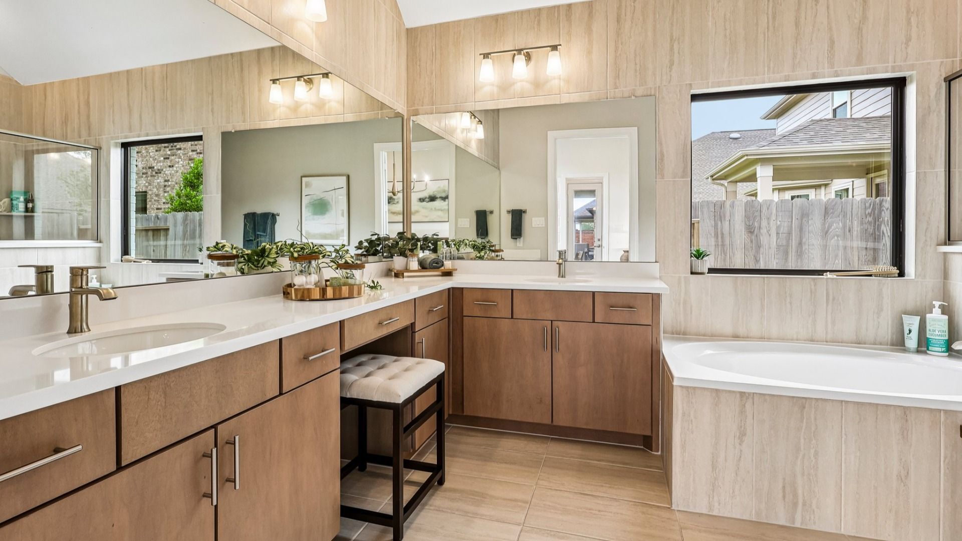 Experience refined elegance with light wood cabinetry and expansive mirrors in Sunterra's serene oasis.