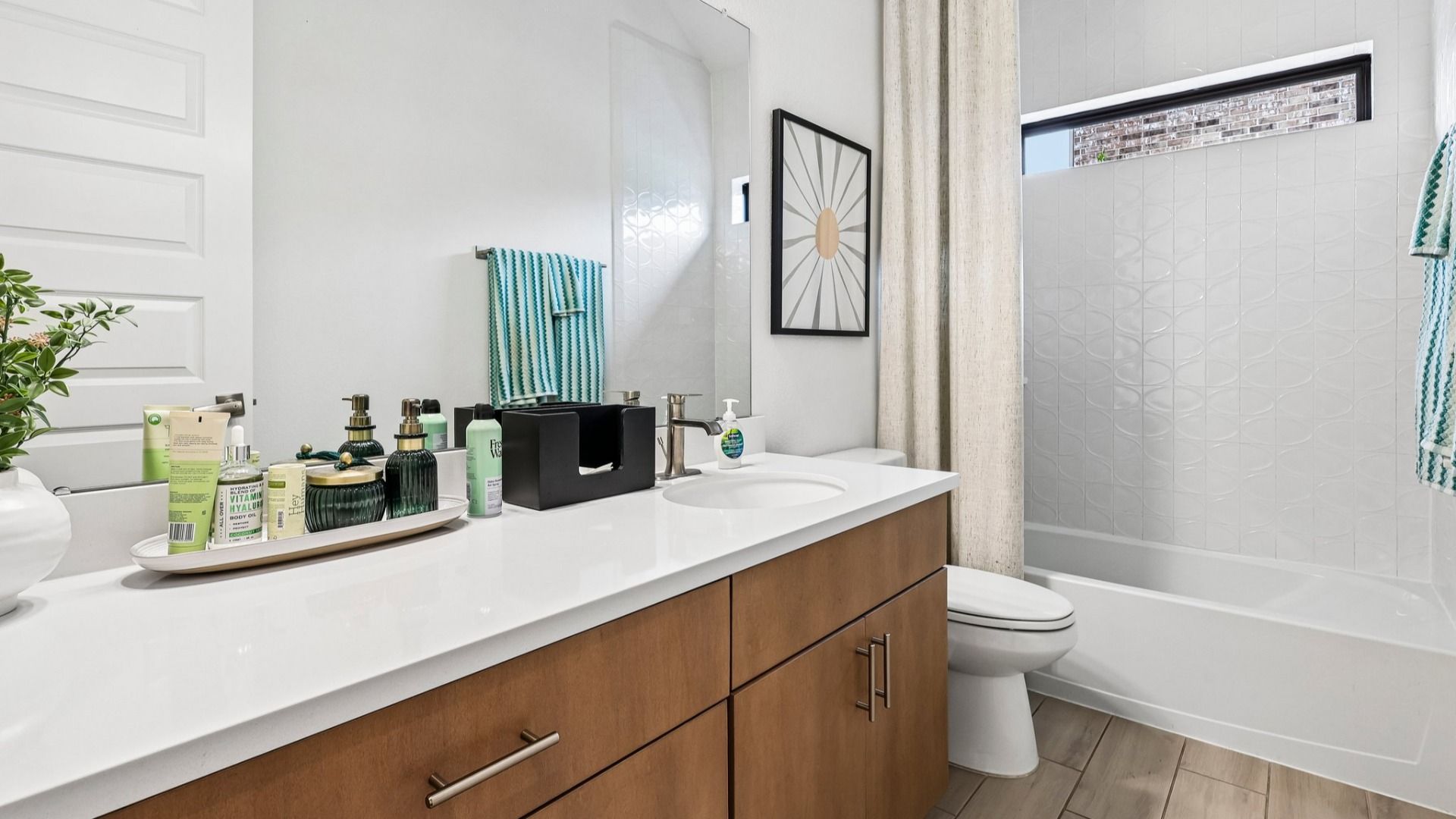 Impeccable subway tile and minimalist fixtures create a serene oasis in Sunterra.