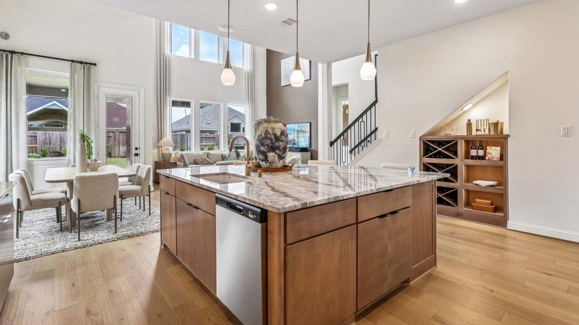 Elegant marble countertops and pendant lights highlight this exquisite kitchen in Brookewater community.