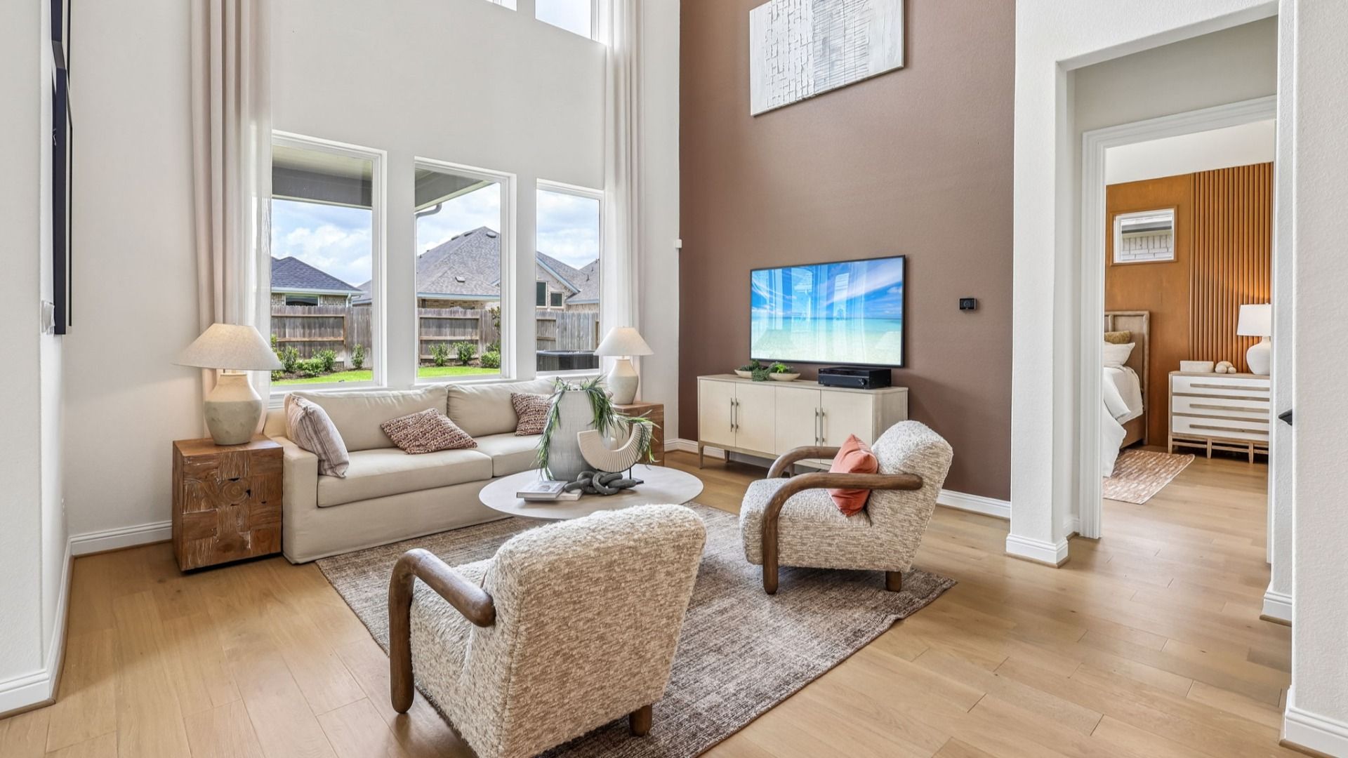 Luxurious high ceilings, expansive windows, and stylish accents define this Brookewater living space.