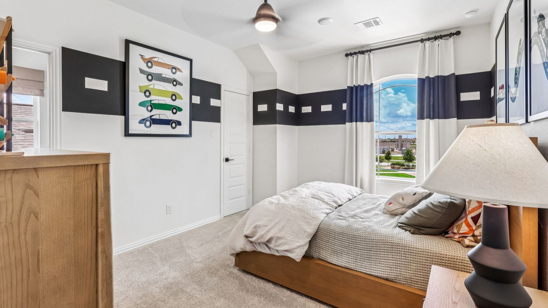 Sleek design with striking black accents and elegant lighting in Brookewater bedroom.