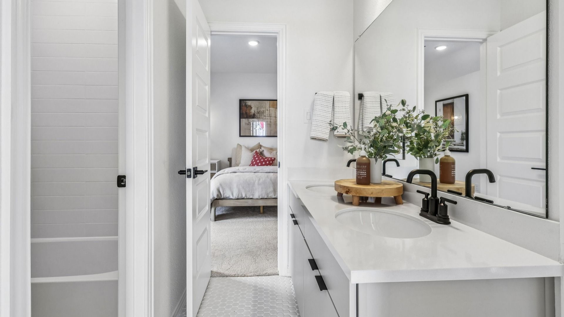 Sleek dual-sink bathroom with elegant matte black fixtures in Brookewater.
