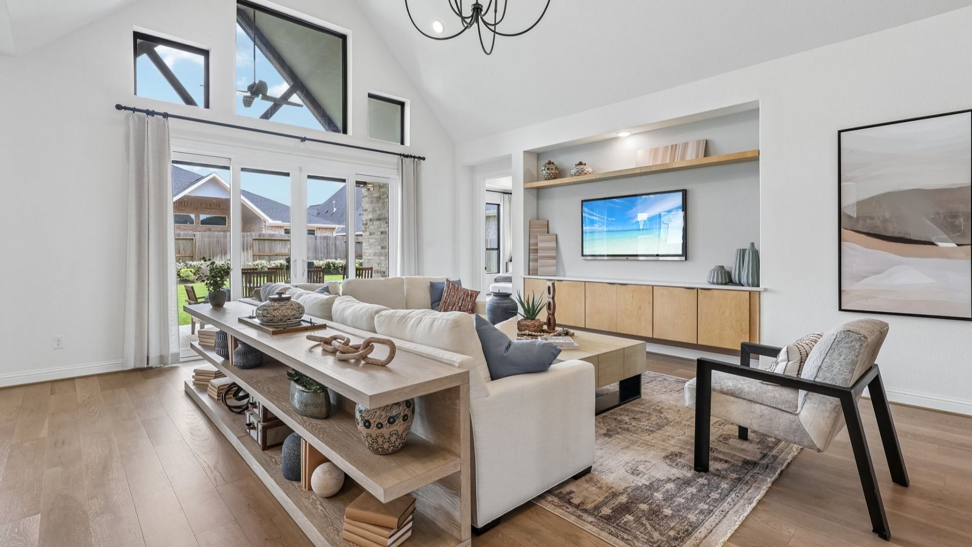 Experience elegant living with vaulted ceilings, chic chandelier, and modern decor in Brookewater.