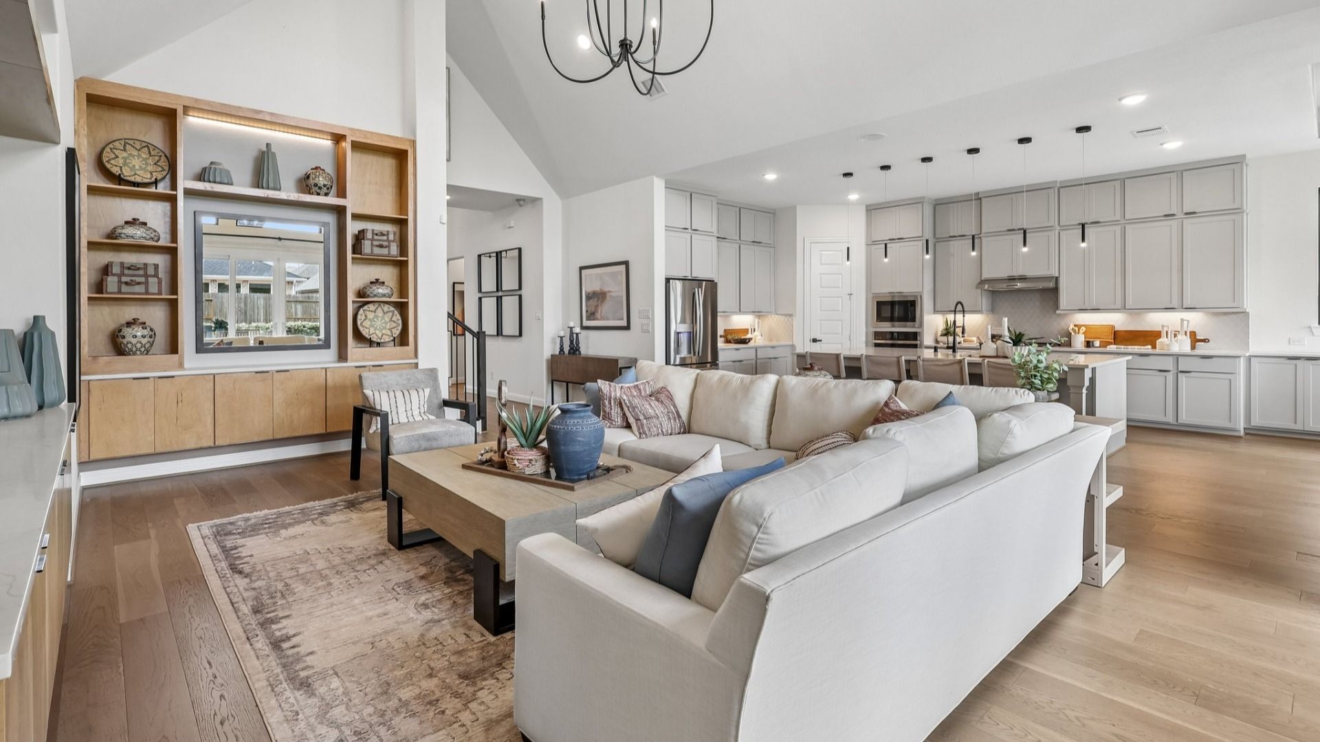 Experience luxury in Brookewater with airy vaulted ceilings and sleek, modern kitchen design.