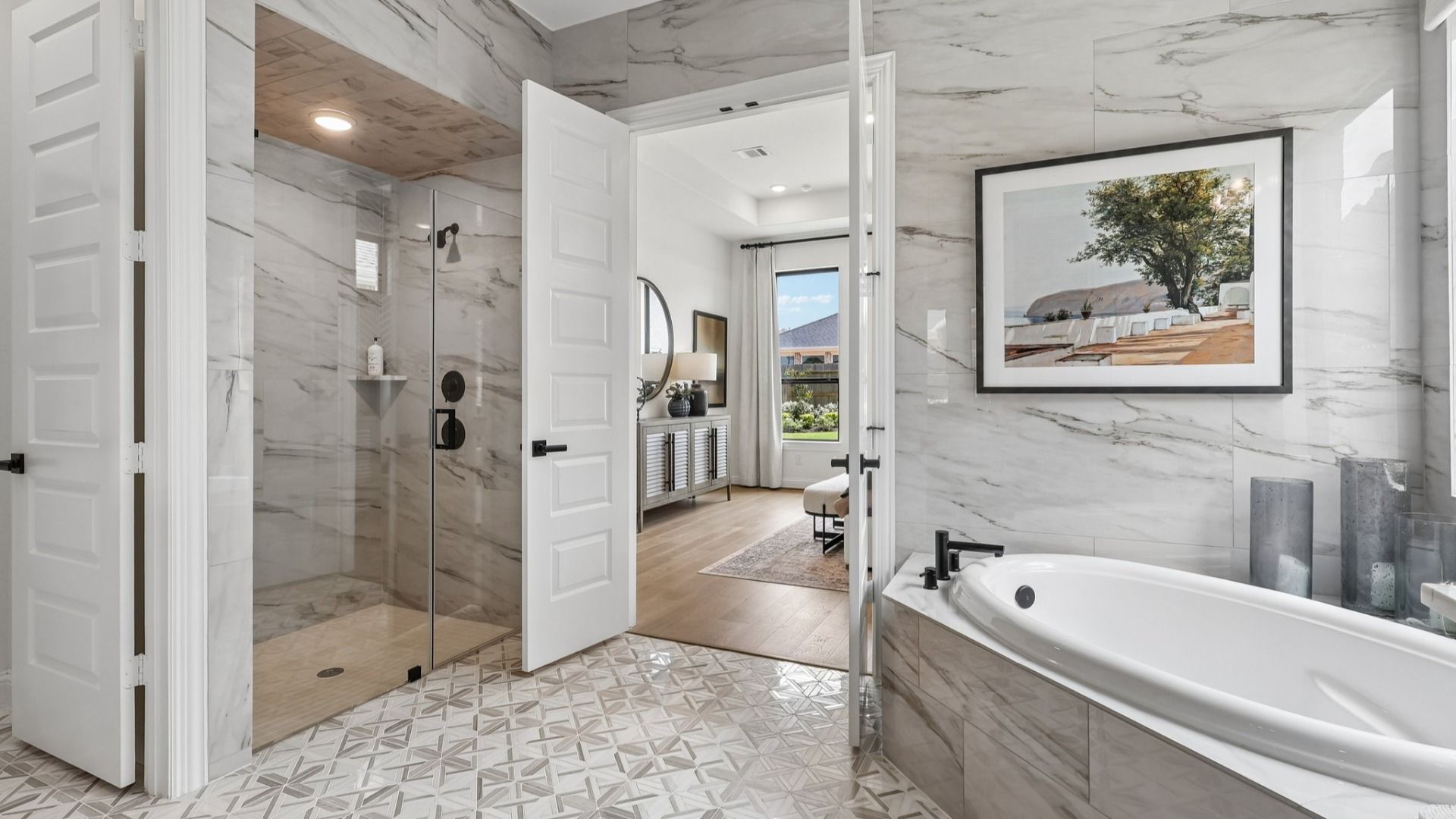 Brookewater's bathroom boasts elegant marble tiles, a luxurious soaking tub, and expansive glass shower.