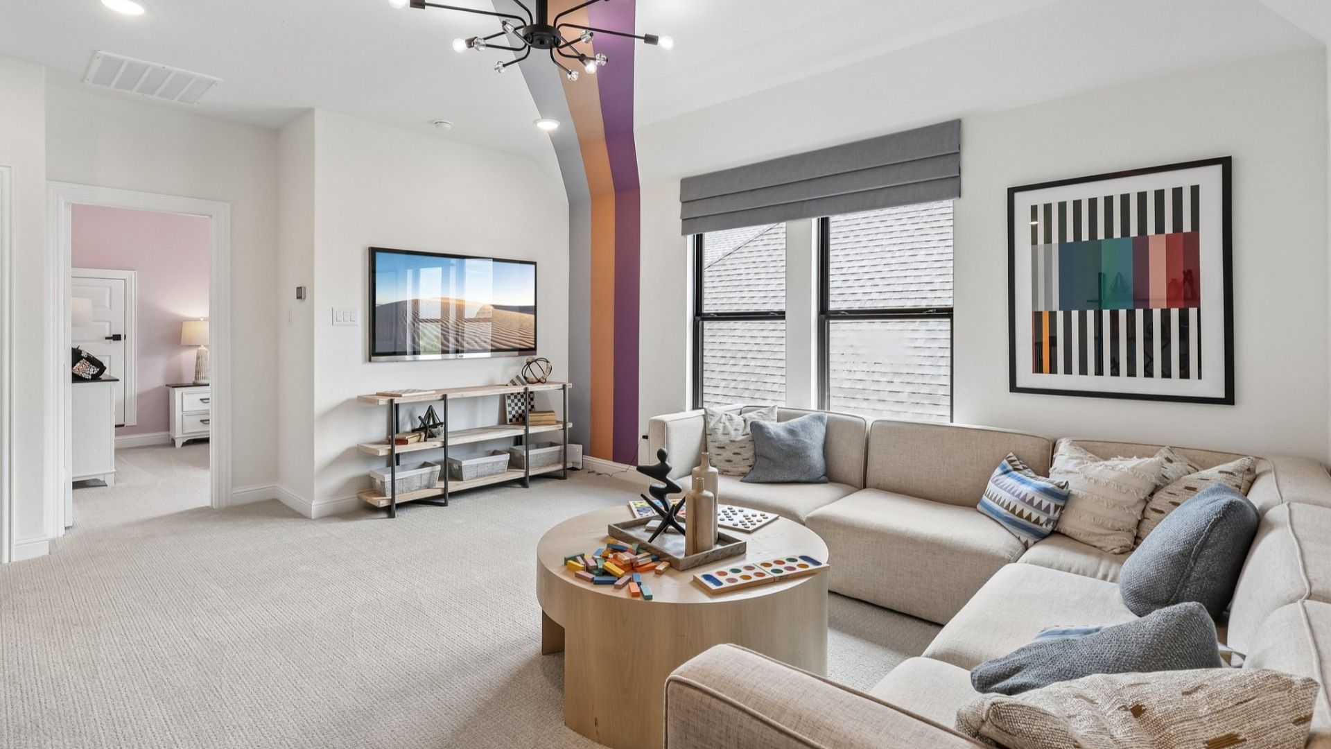 Experience luxury in Brookewater with a plush, neutral sofa, bold accent beams, and elegant railing.