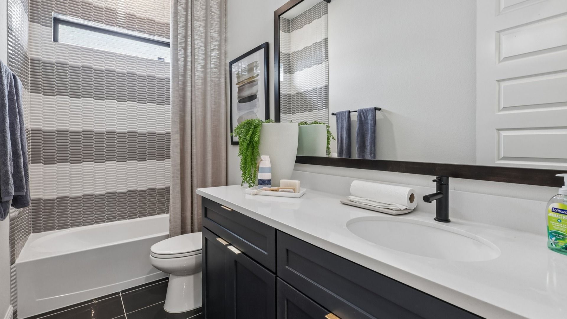 Luxurious matte black finishes meet exquisite textured tiles in Brookewater's sophisticated bathroom design.