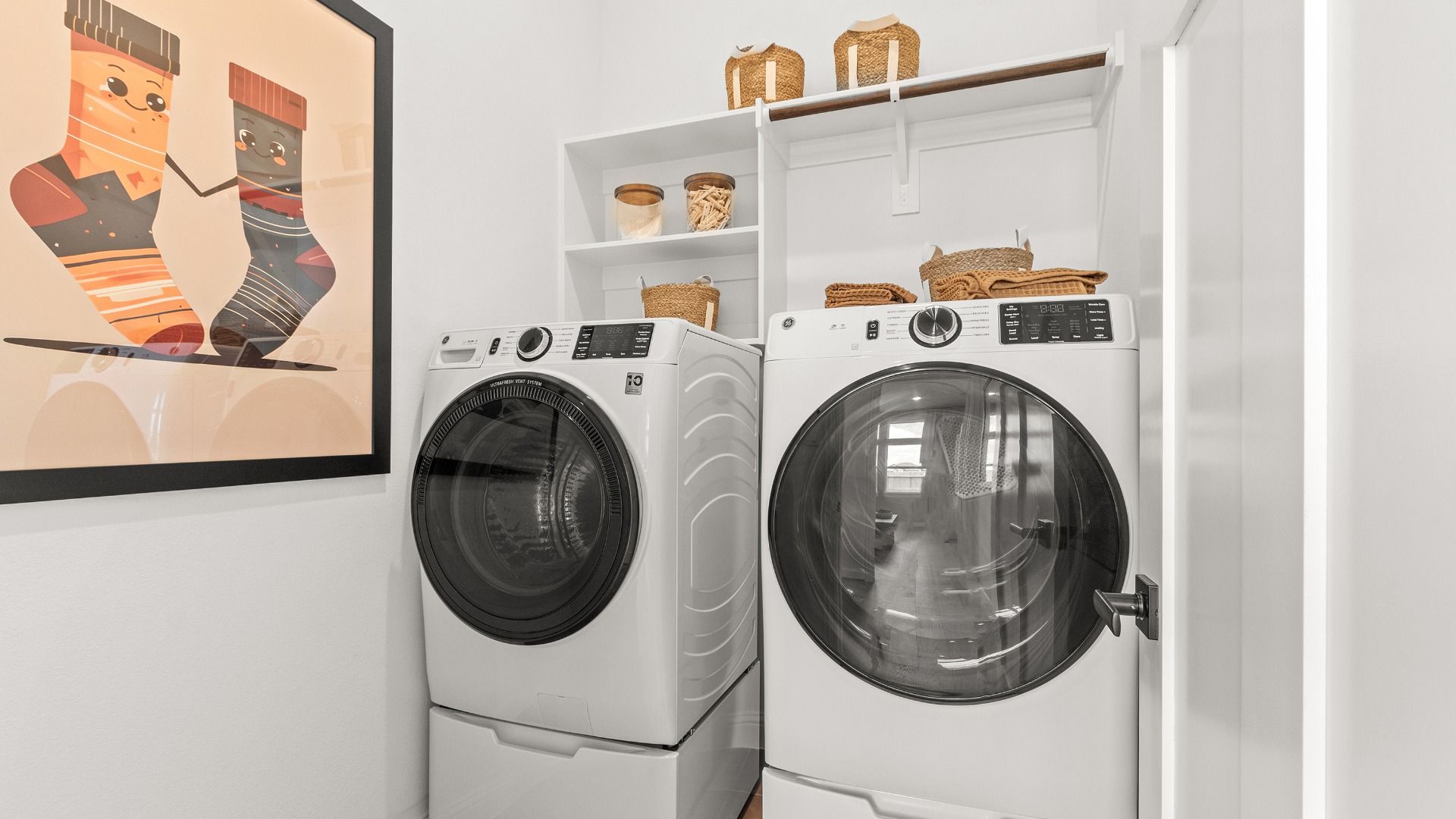 Bright laundry room with ample storage space in Wildrye by DRB Homes.