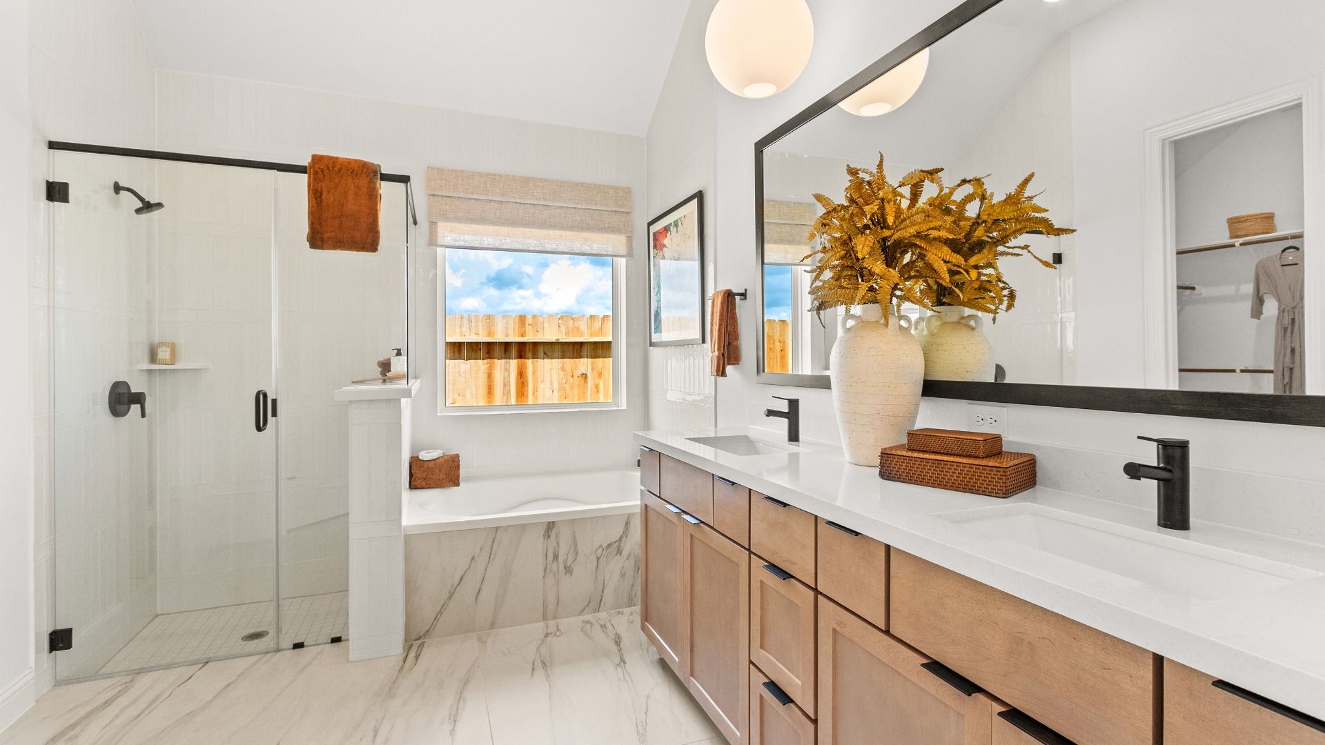 Discover sophisticated bathroom design in Azalea with dual vanities, designer lighting, and warm-toned cabinetry.