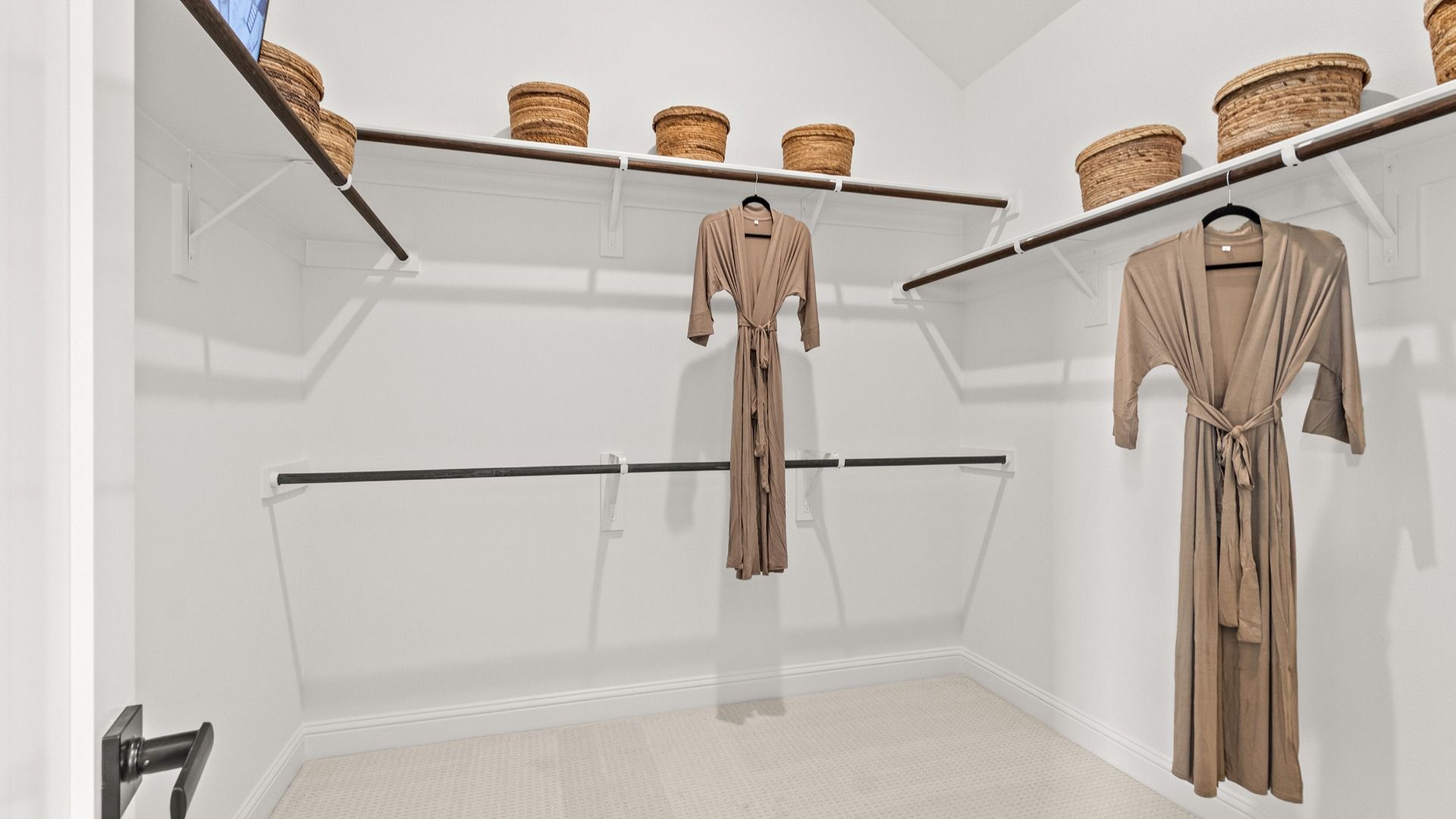 Multiple hanging spaces and an oversized layout make this walk-in closet in Azalea both luxurious and practical.
