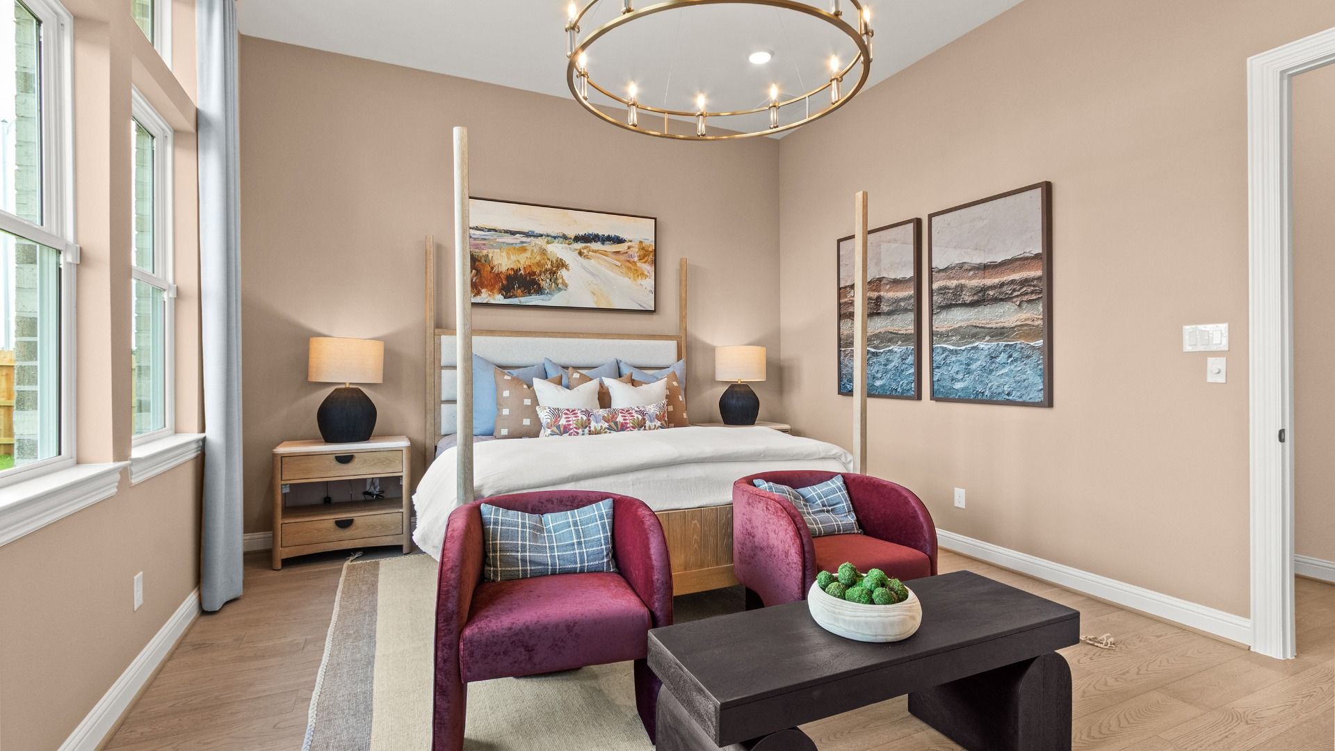 Large windows and refined design create a serene living space in this luxurious primary bedroom in Azalea.