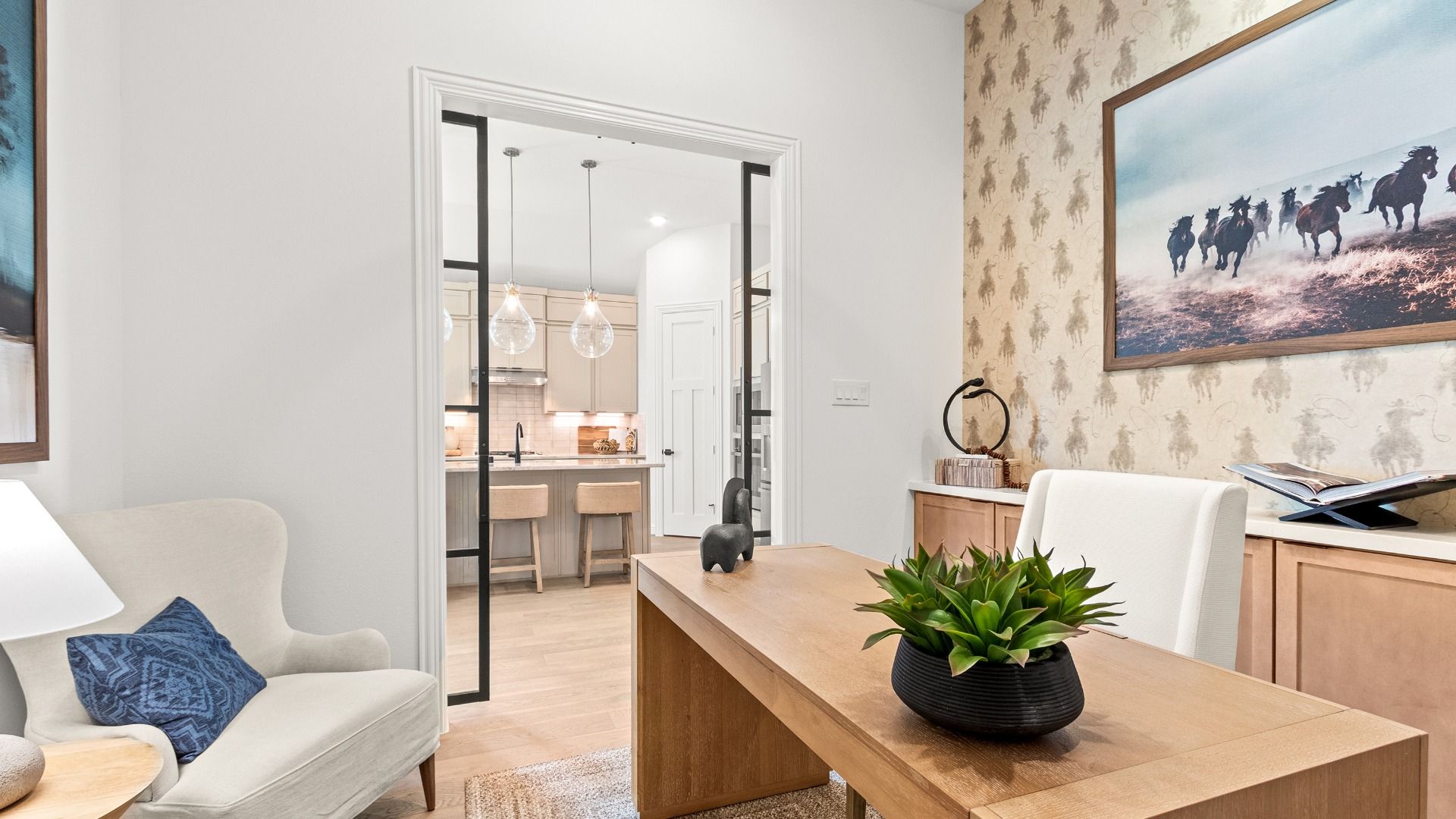 This study in Azalea features a striking western accent wall and view into the kitchen area for a connected, modern feel.