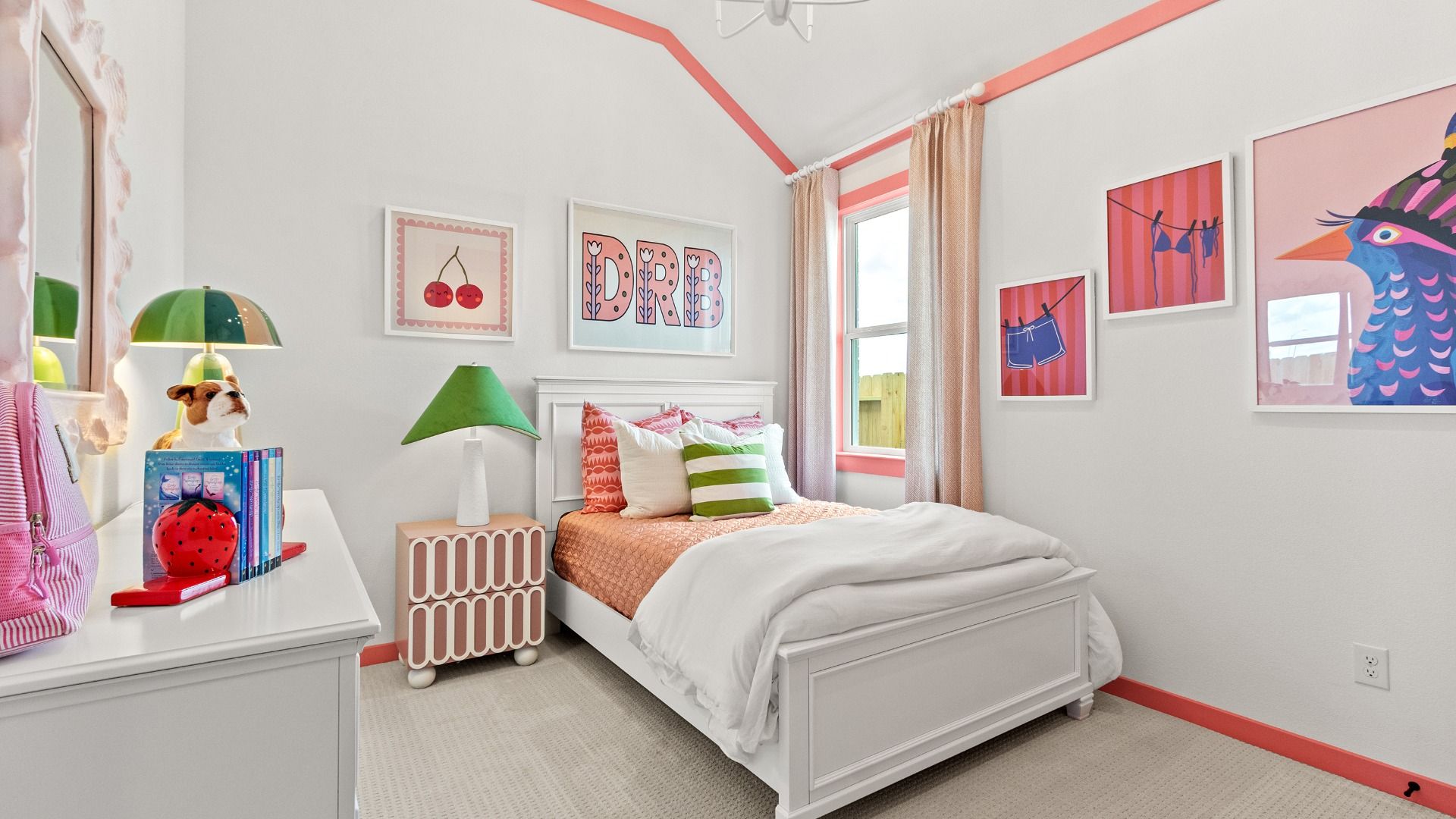 Crisp white walls and soft pink accents create a bright, fun atmosphere in this beautifully designed bedroom in Azalea.