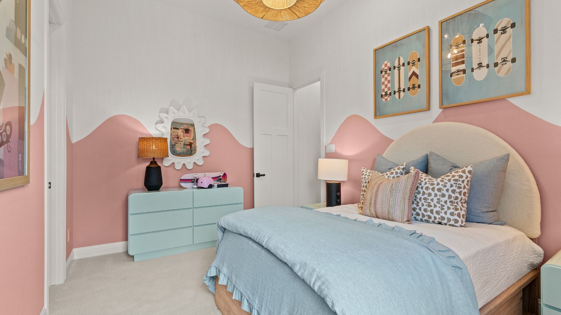 Soft pink and crisp white walls create a bright, cheerful atmosphere in this secondary bedroom.