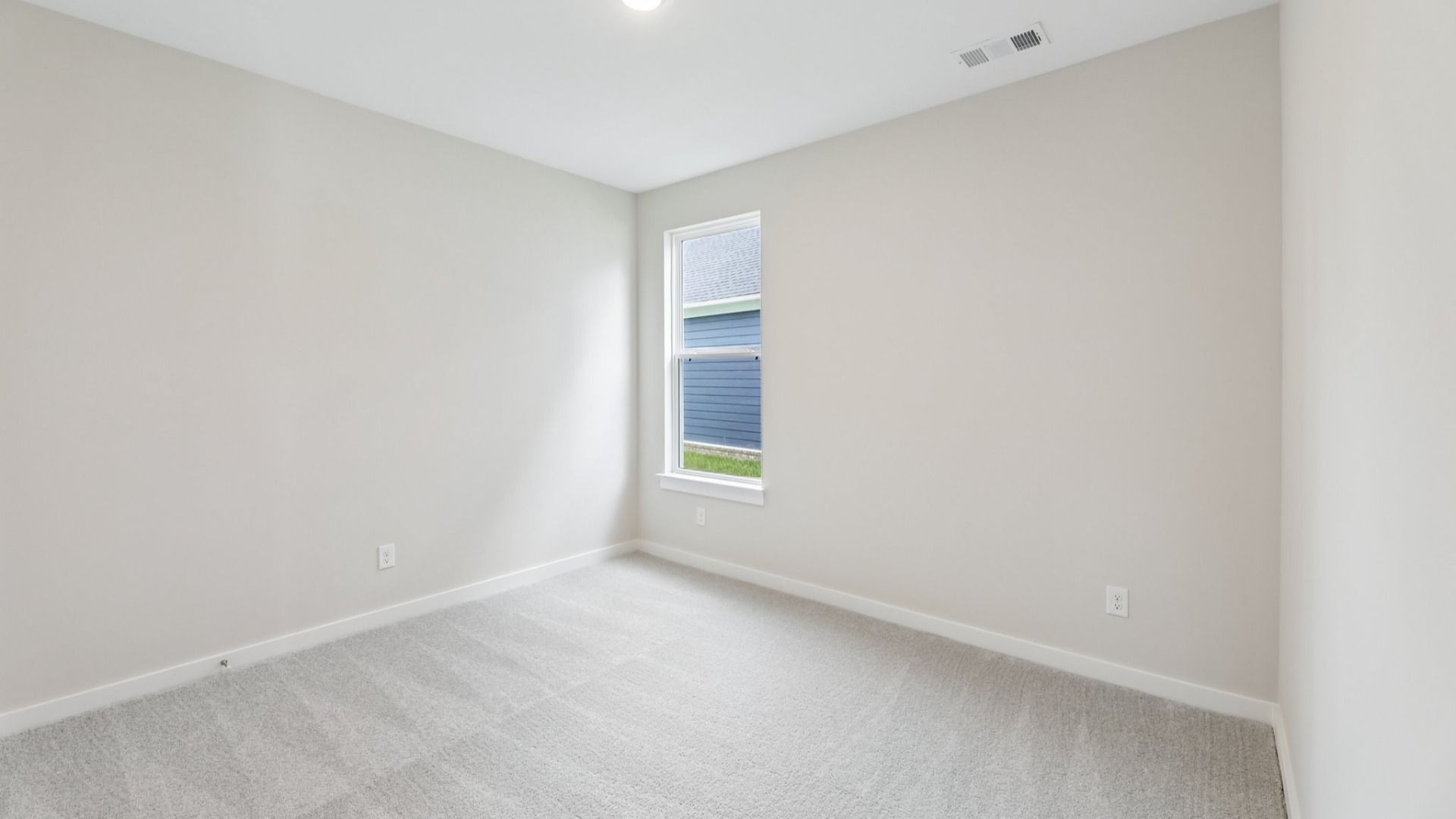 Secondary Bedroom with carpet and window