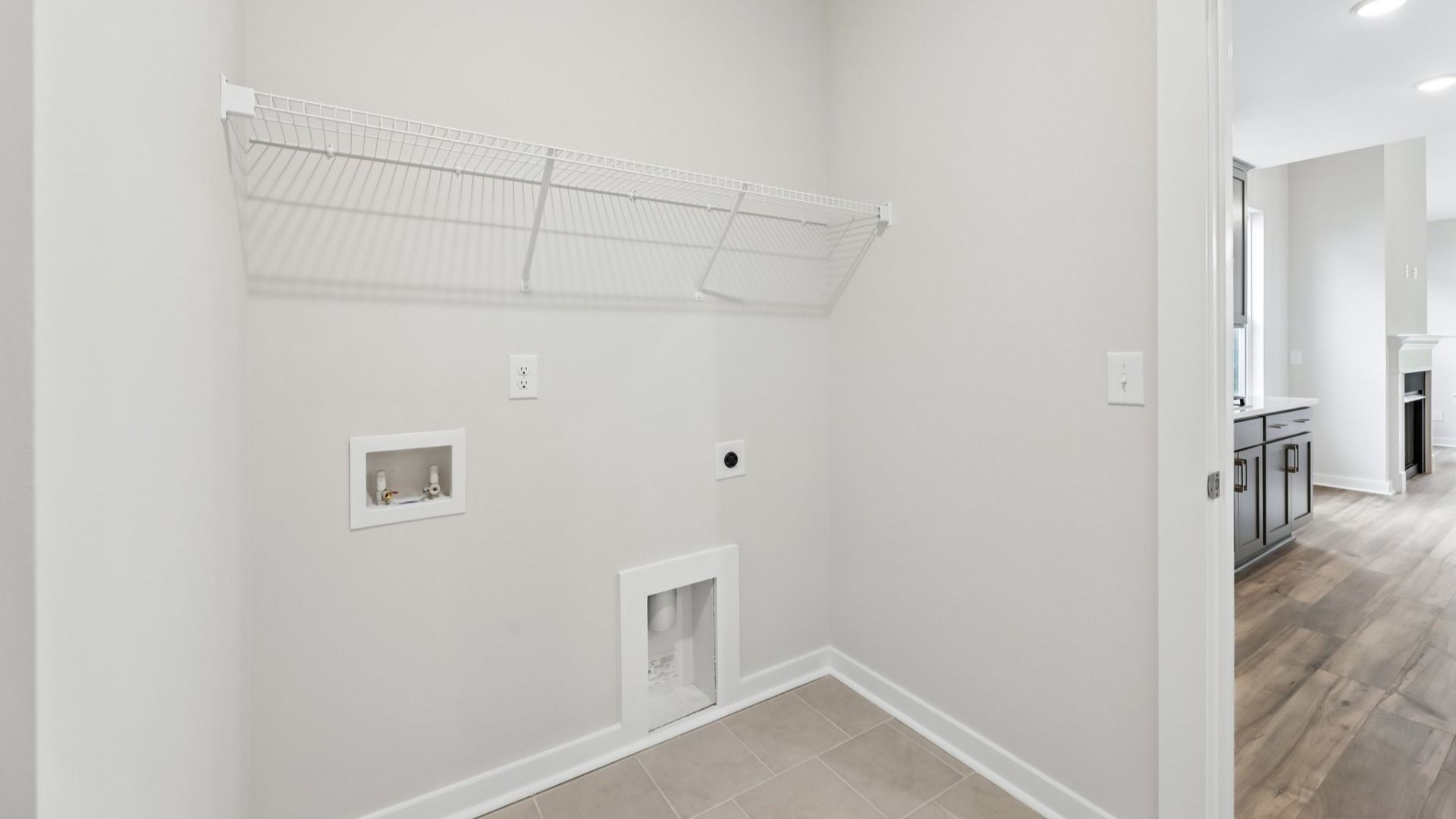 Dedicated laundry room with ventilated shelf