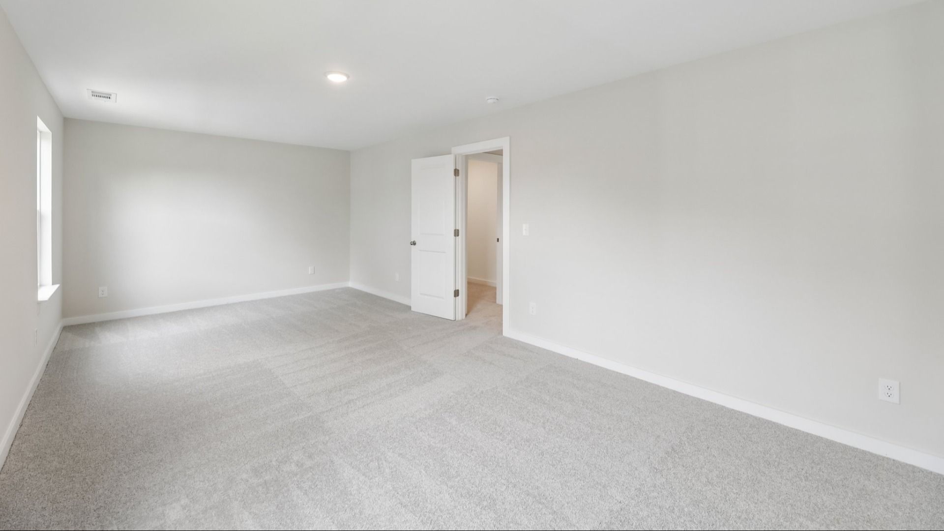 Storage room with carpet and windows