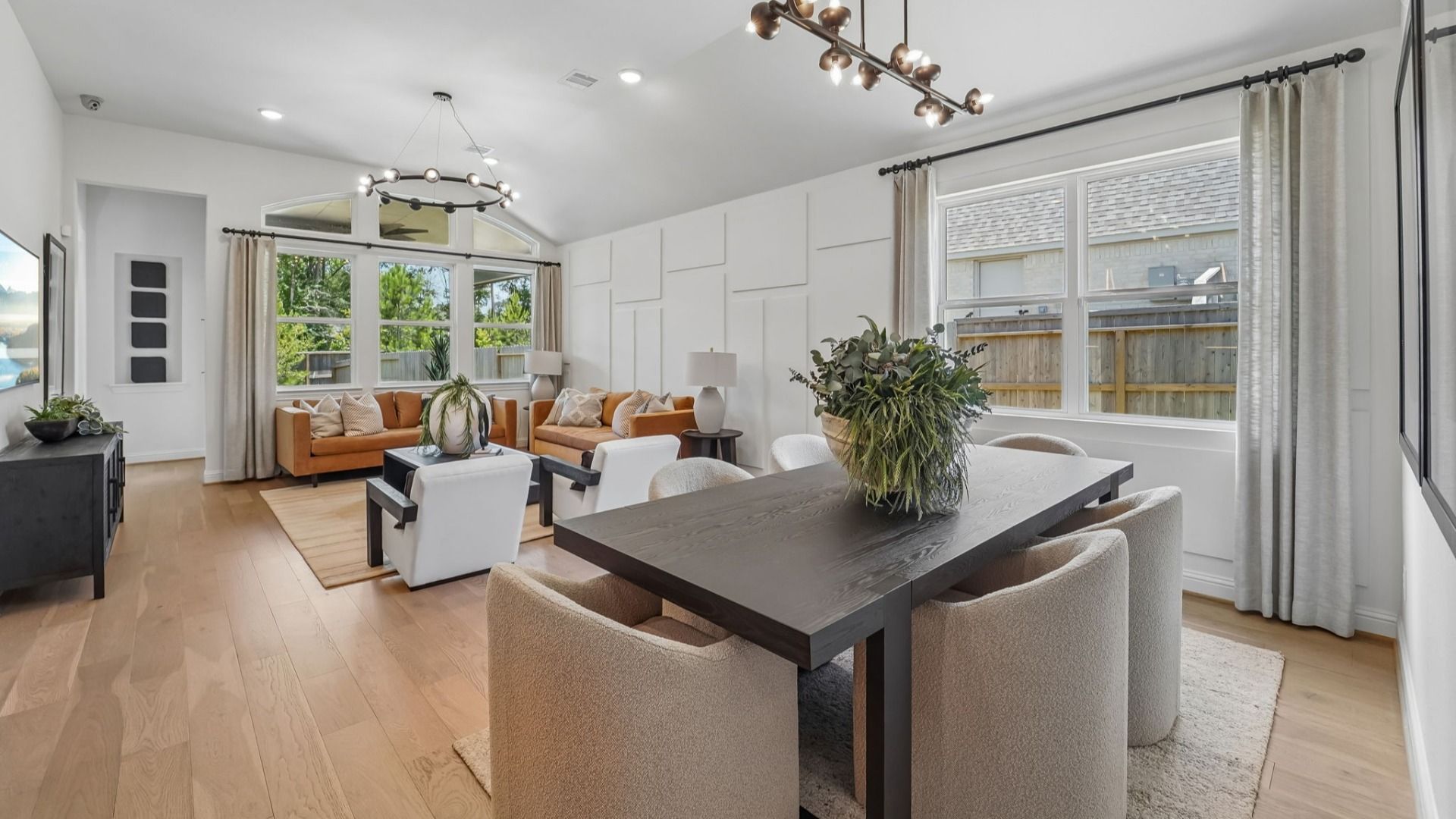 Elegant pendant lighting and refined hardwood floors accentuate this modern abode in The Woodlands Hills.